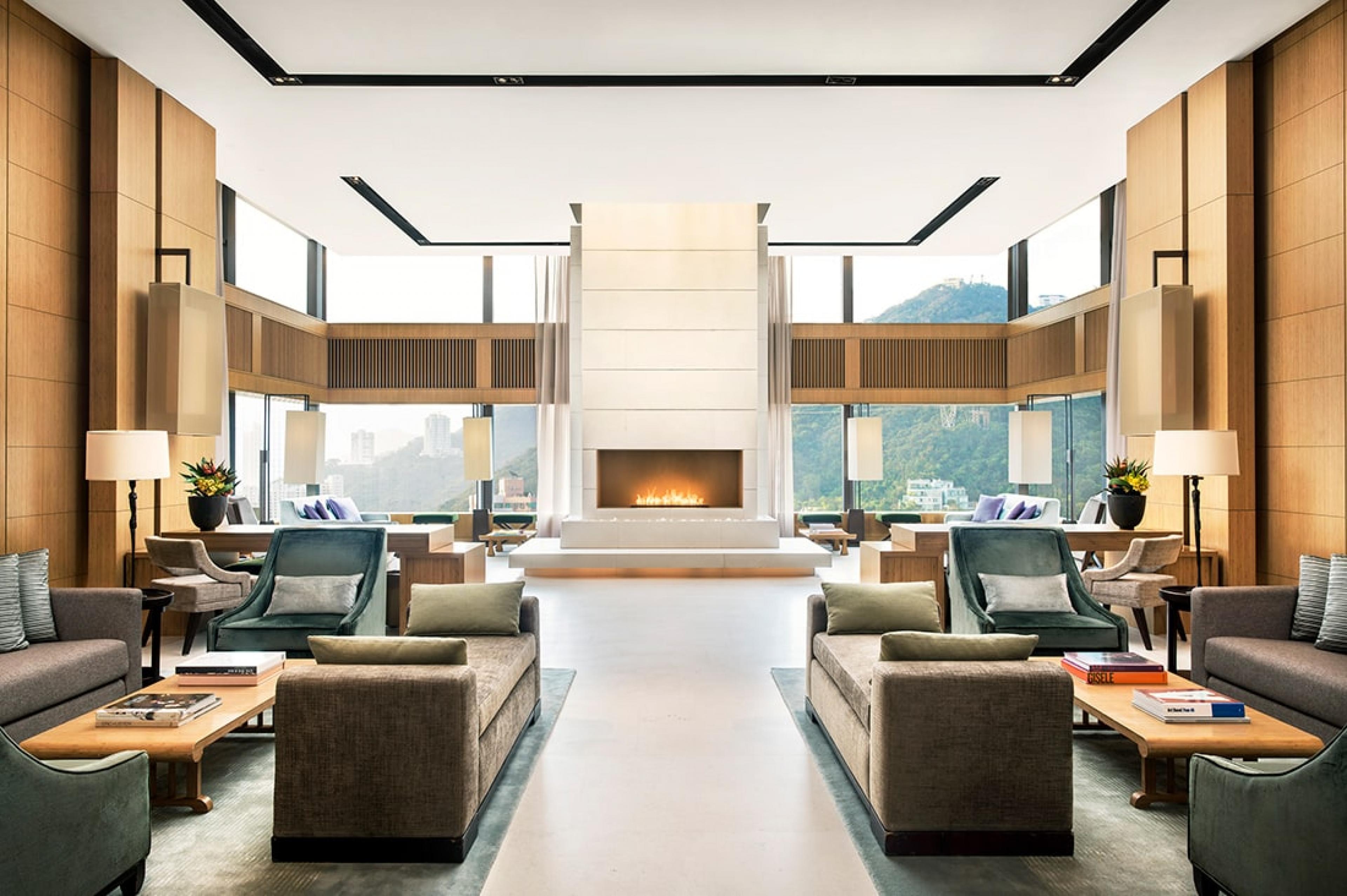 lounge with fireplace and lounge seating with floor-to-ceiling windows in back