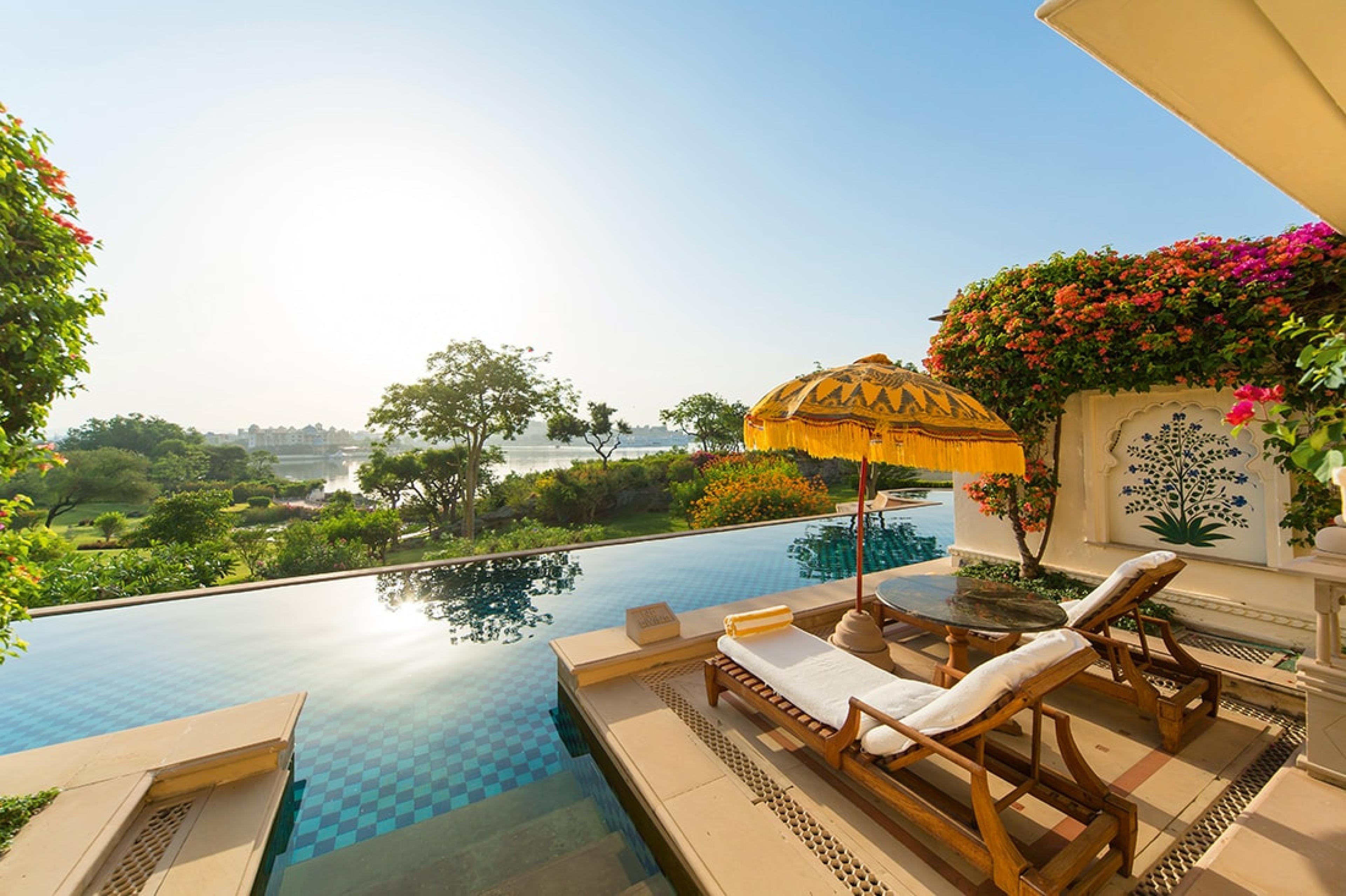 two lounge chairs by pool 