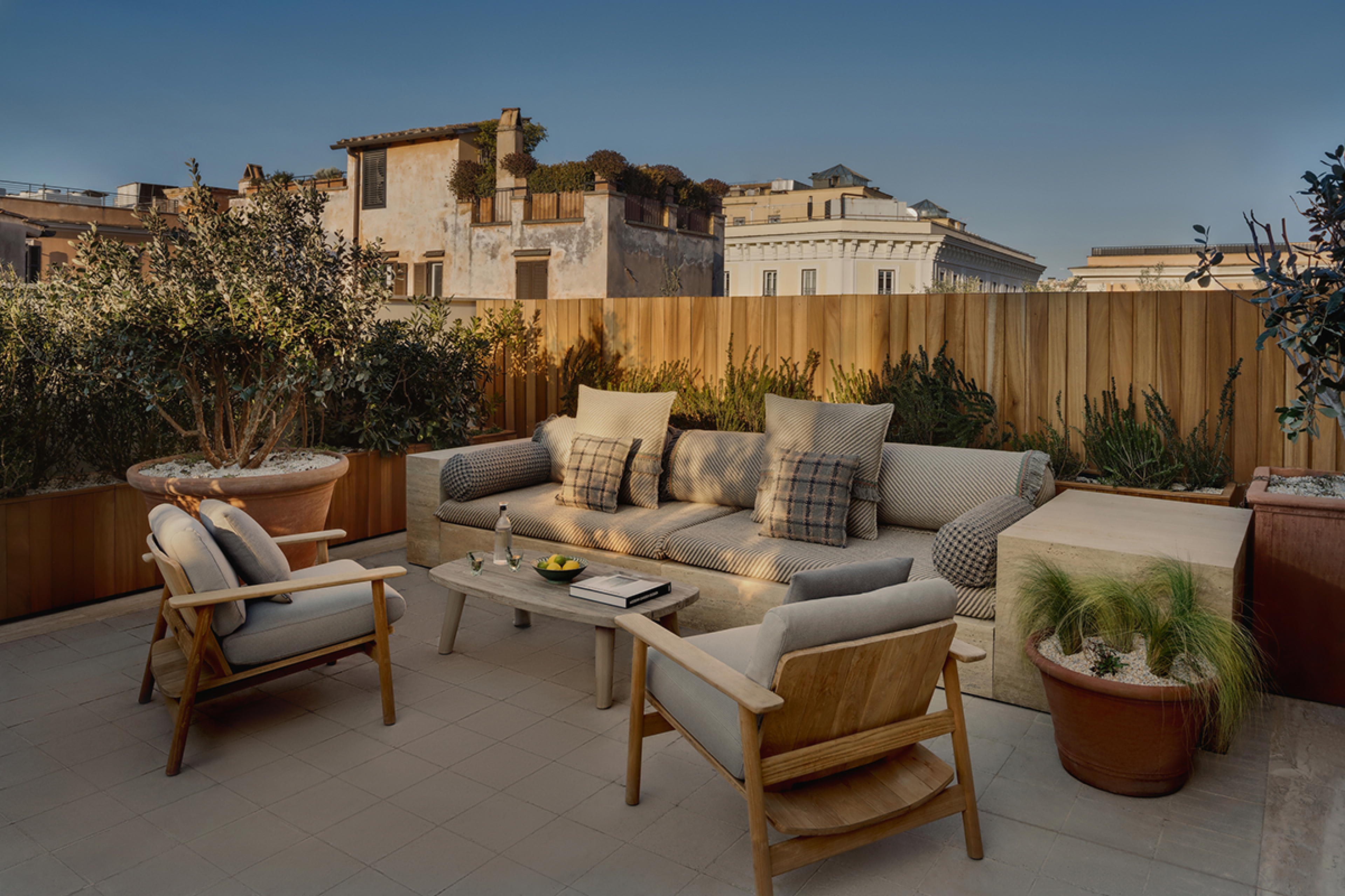 Terrace Suite overlooking Rome with a sofa and two chairs around a coffee table