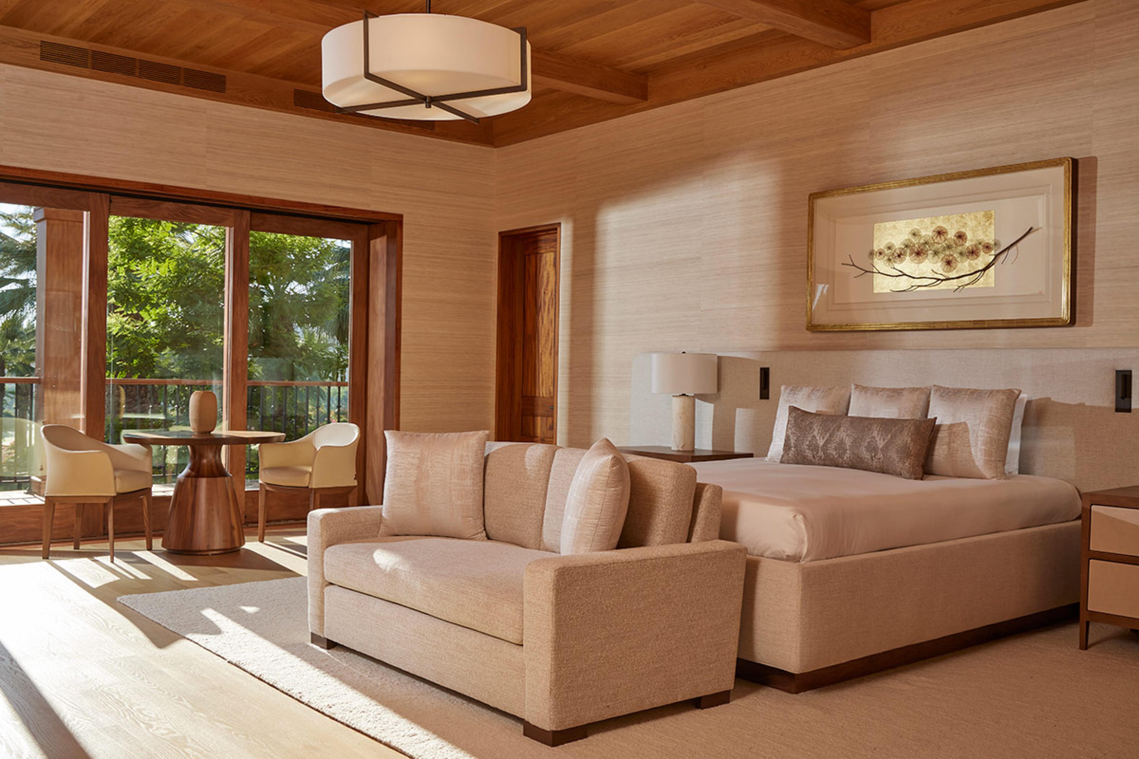 hotel room with wooden ceilings and beige furniture