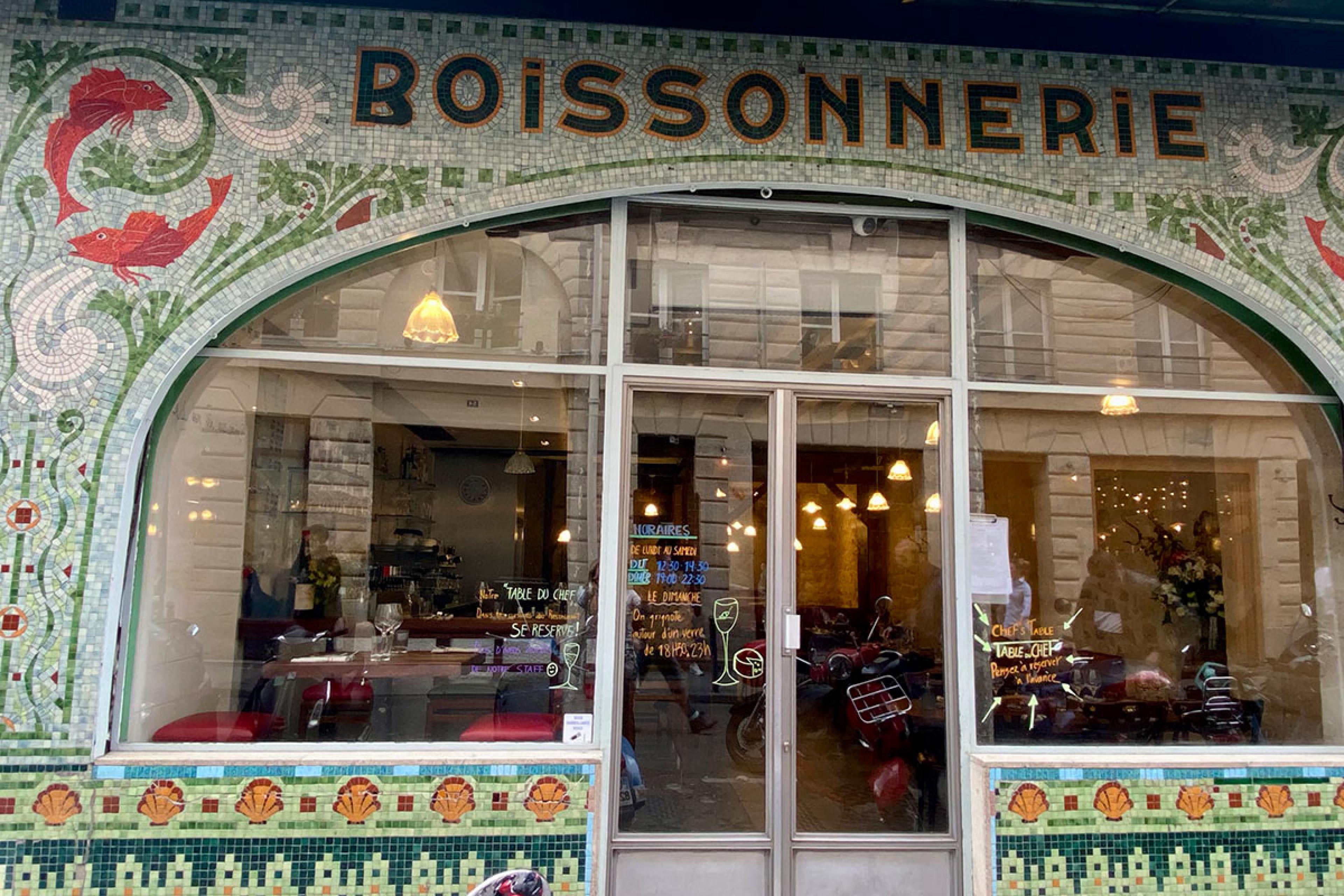 outside french restaurant in paris with sign saying boissonnerie