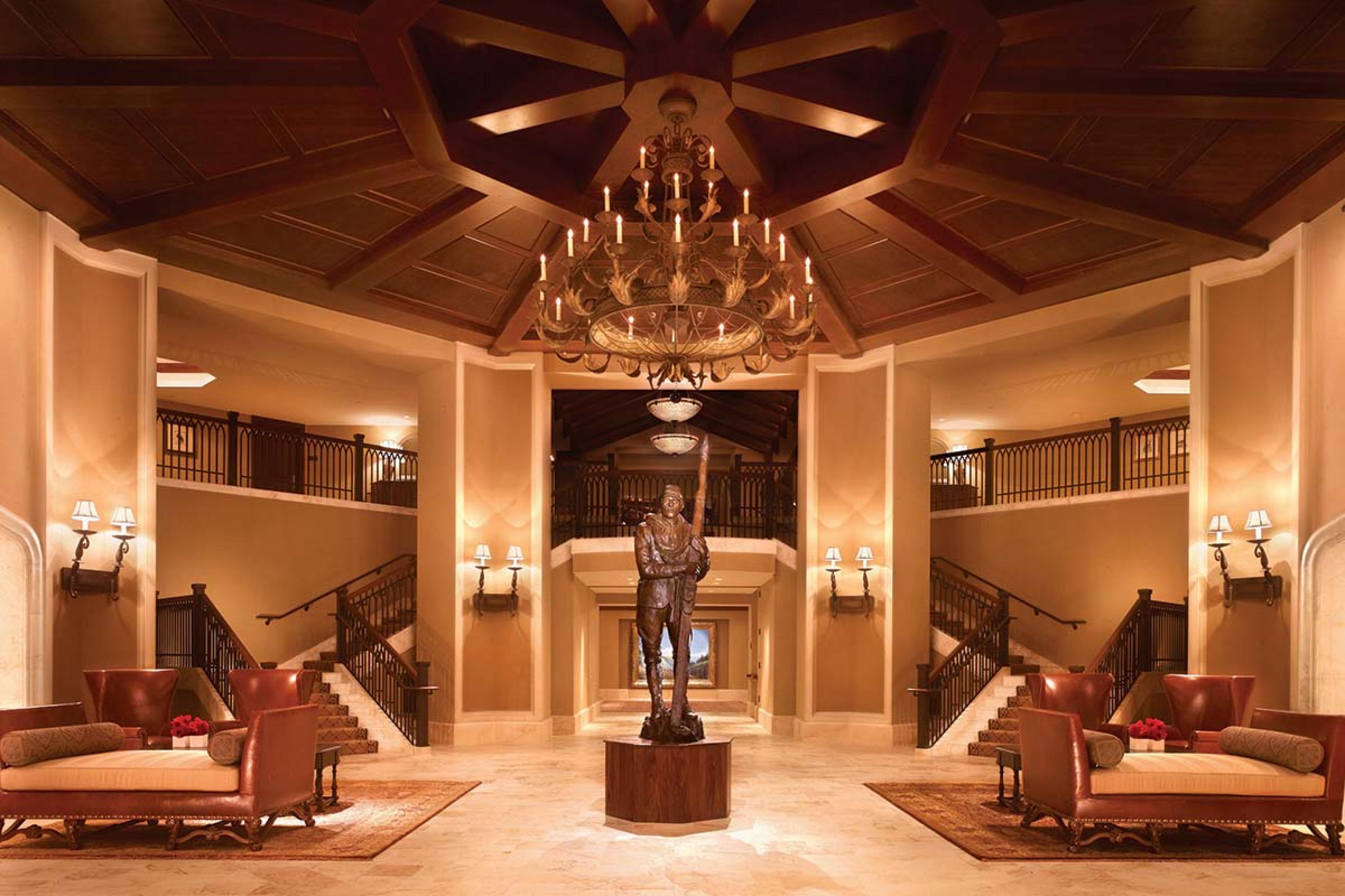 large entry hall with polished wood and a ski statue