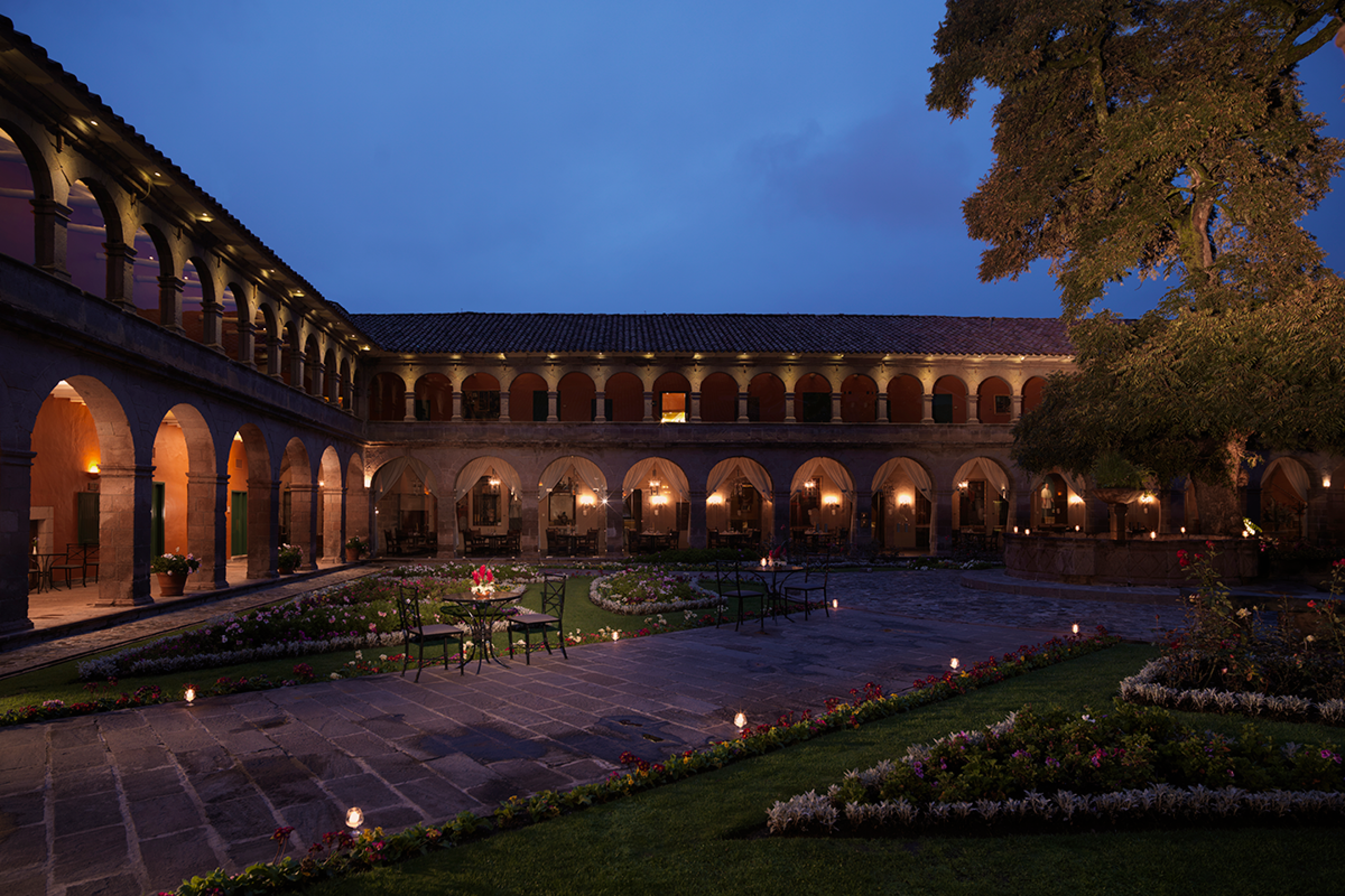 Courtyard lit up at night with candles