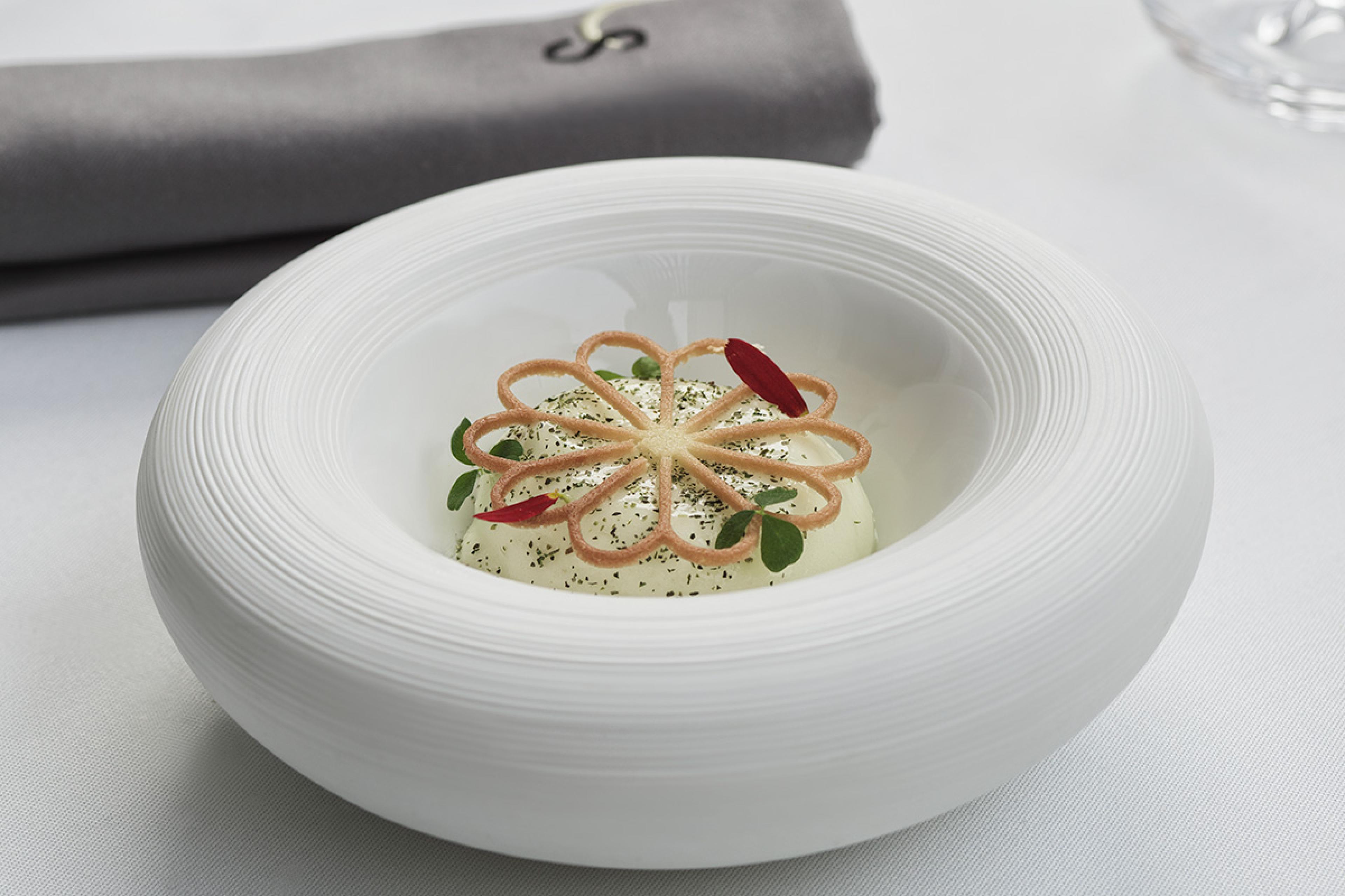 appetizer with an accent flower in a white ceramic dish