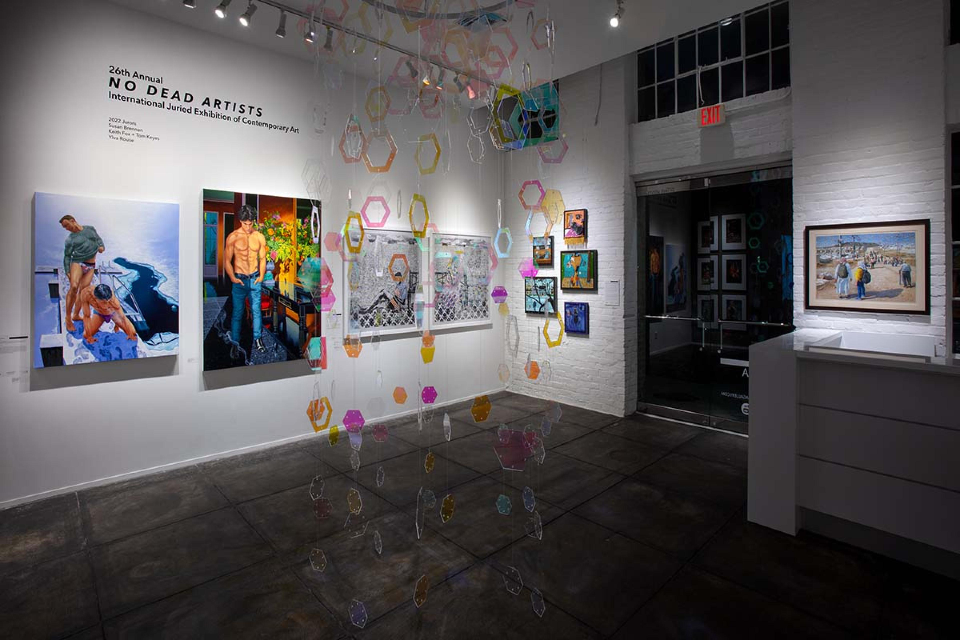 gallery space with colorful circles hanging from the ceiling