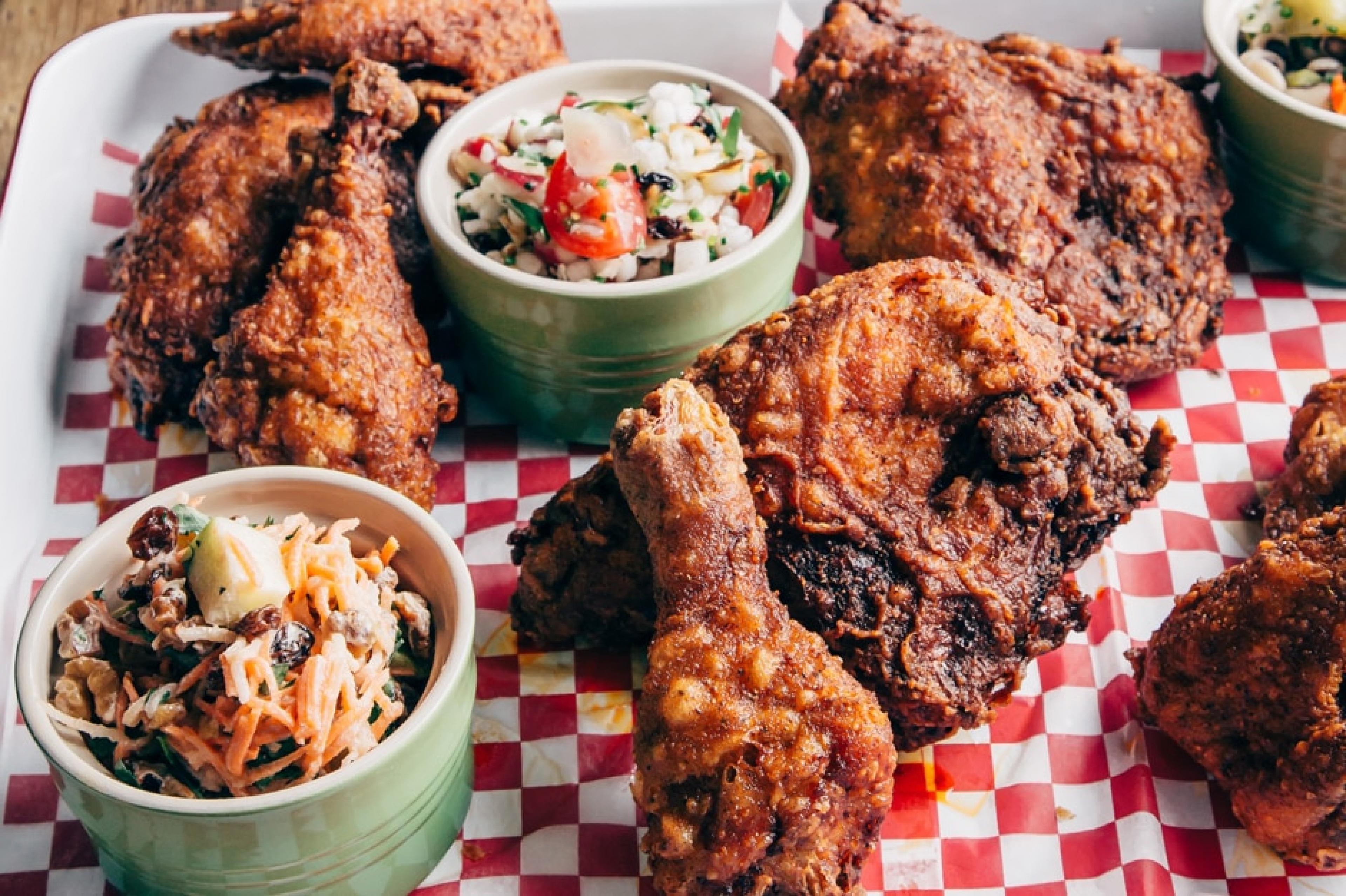fried chicken on a tray with sides of coleslaw 