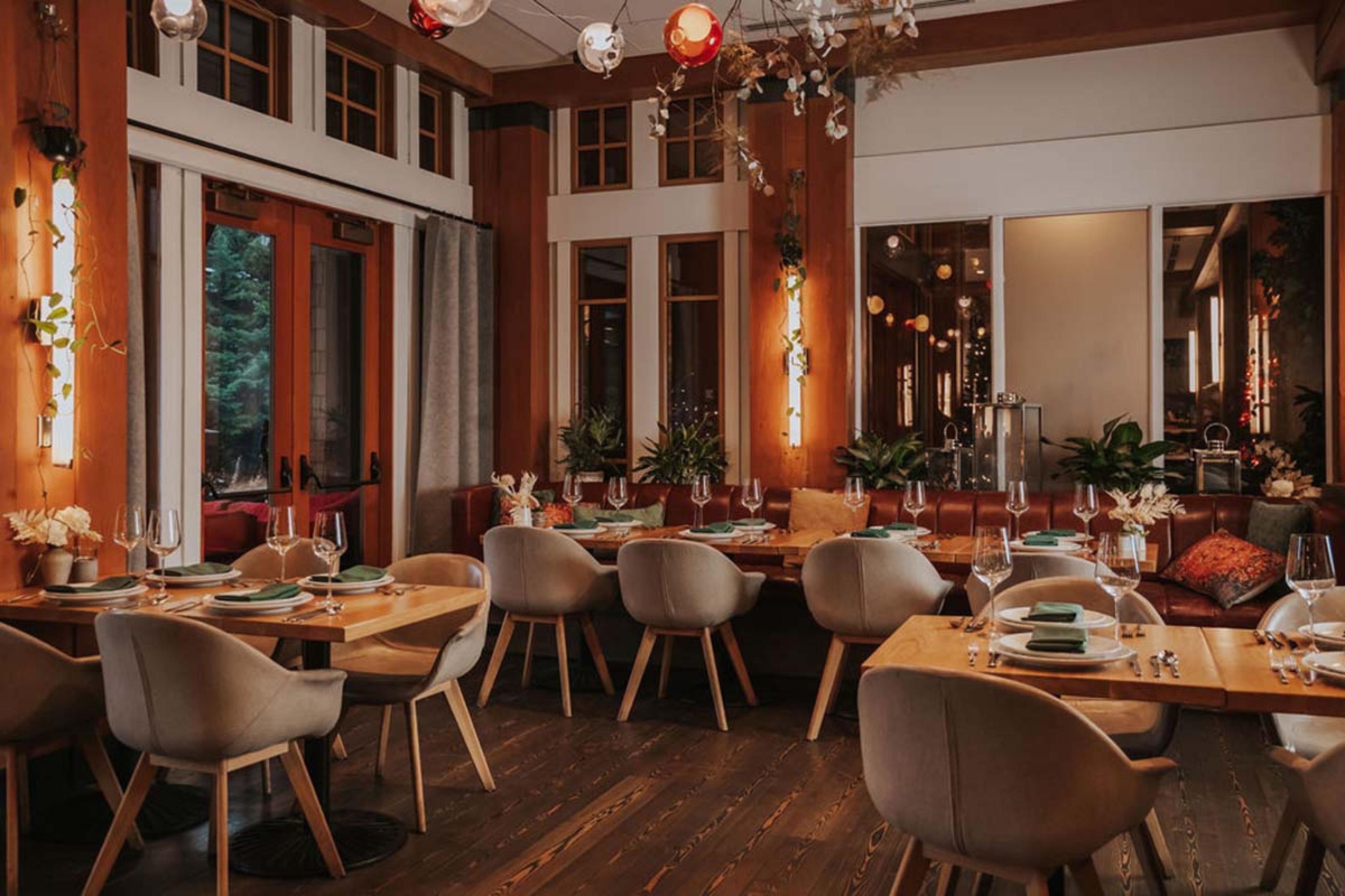 warm dining room with wooden tables and orange lighting