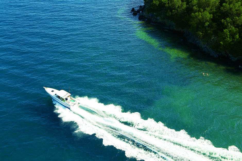 Aerial view of motorized yacht in water off of Corfu in Greece