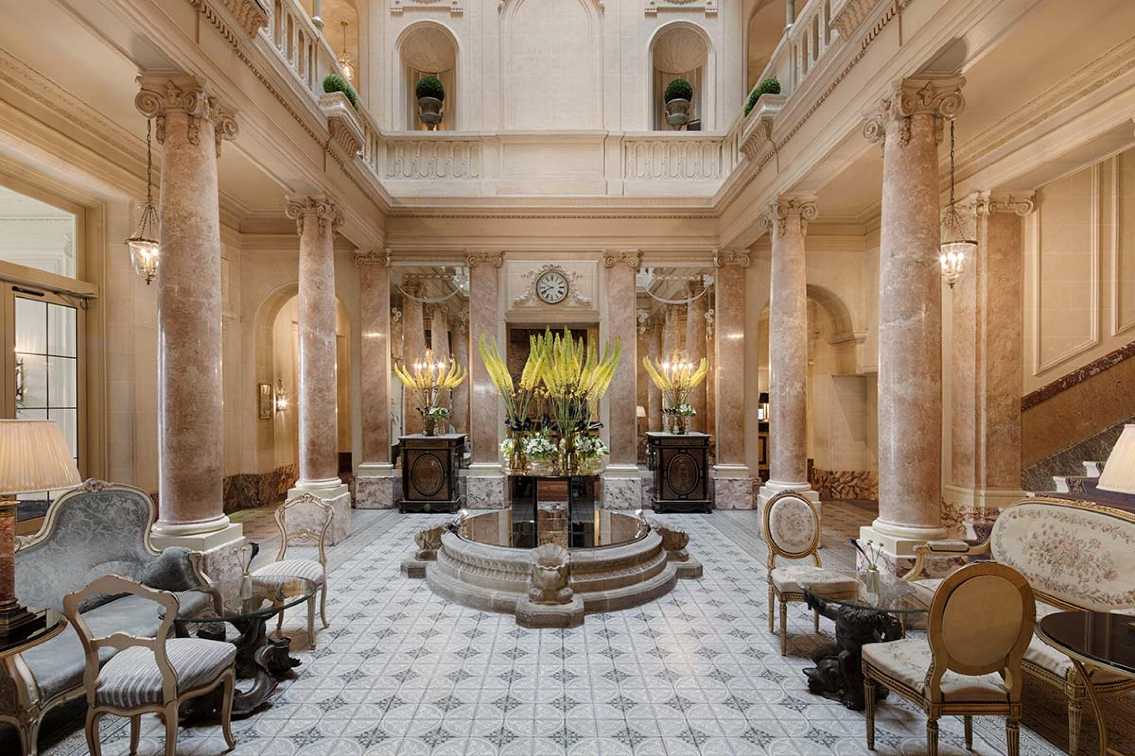 lobby with rose marble column and a fountain in the middle