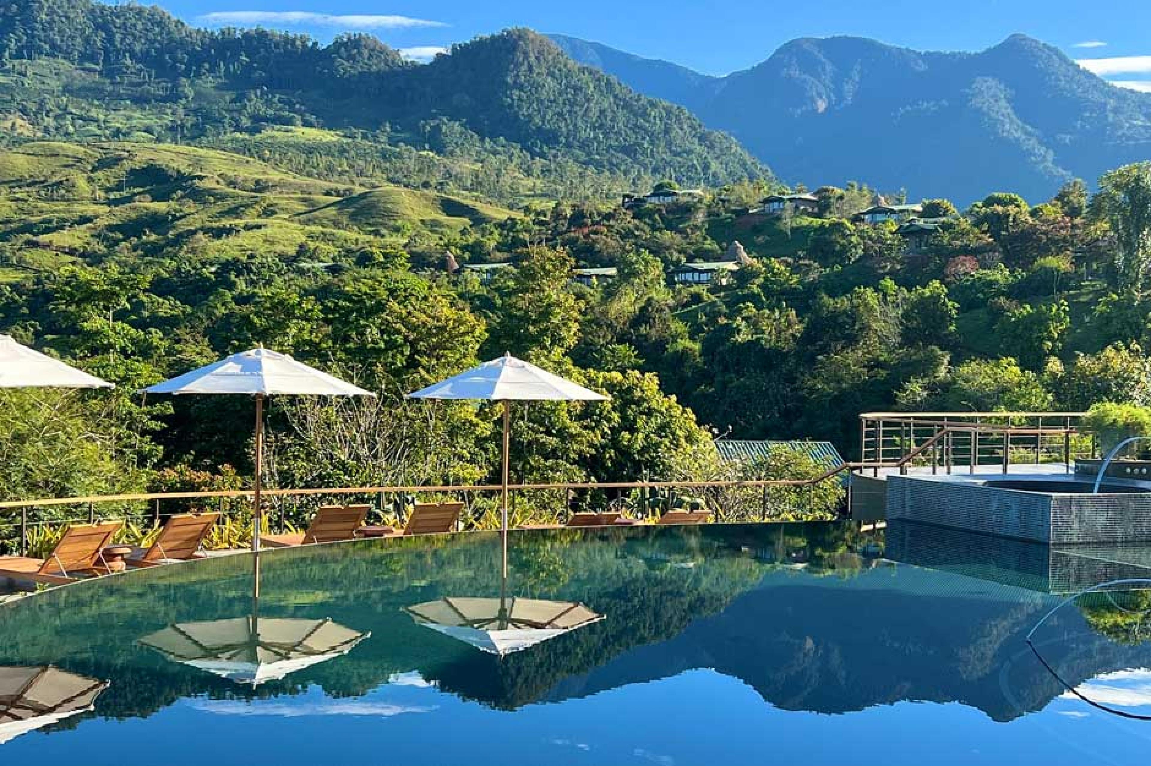Pool view at Hacienda Altagracia in Costa Rica with reflection of umbrellas