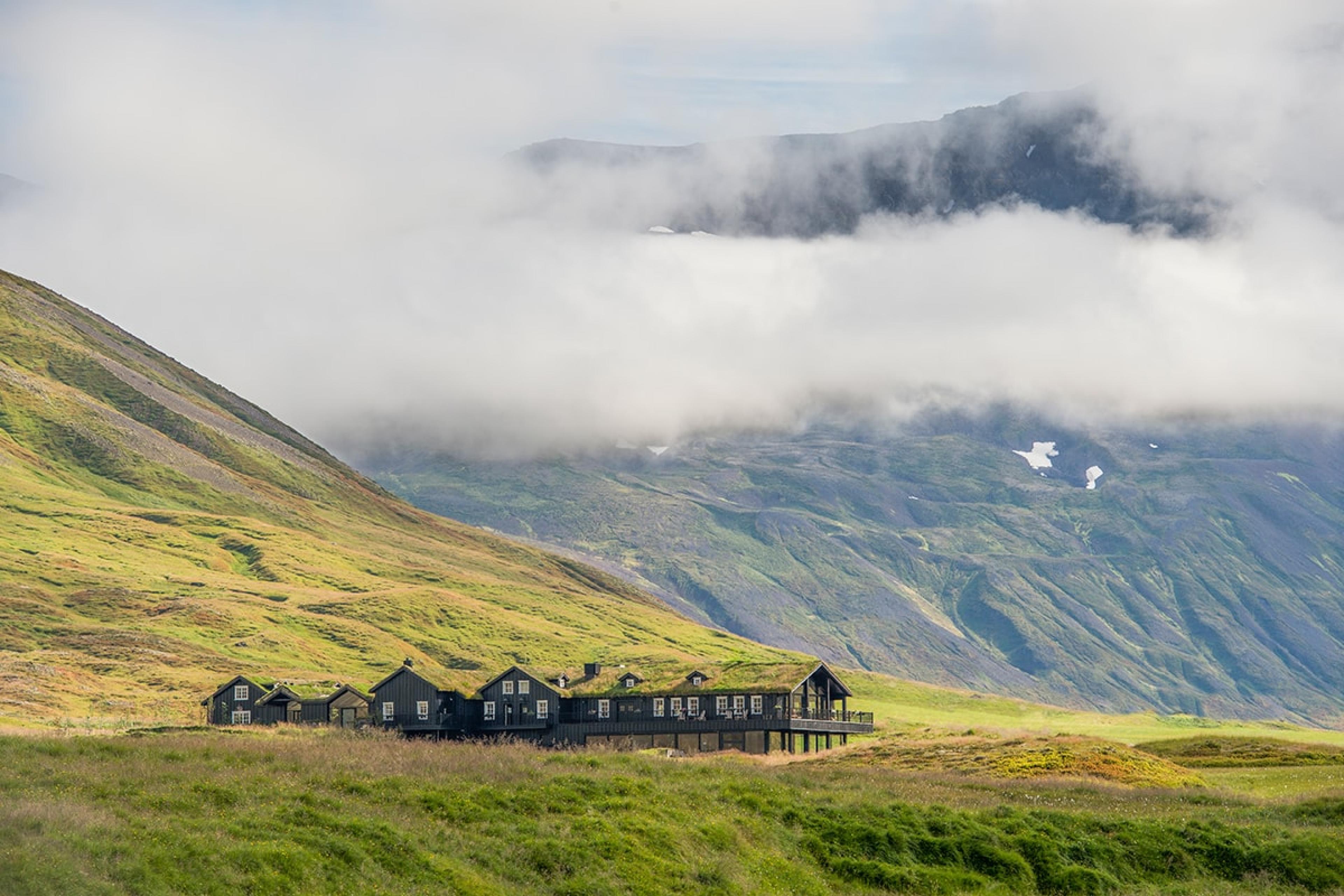 single-story hotel building with grass-covered roof blending into landscape of iceland