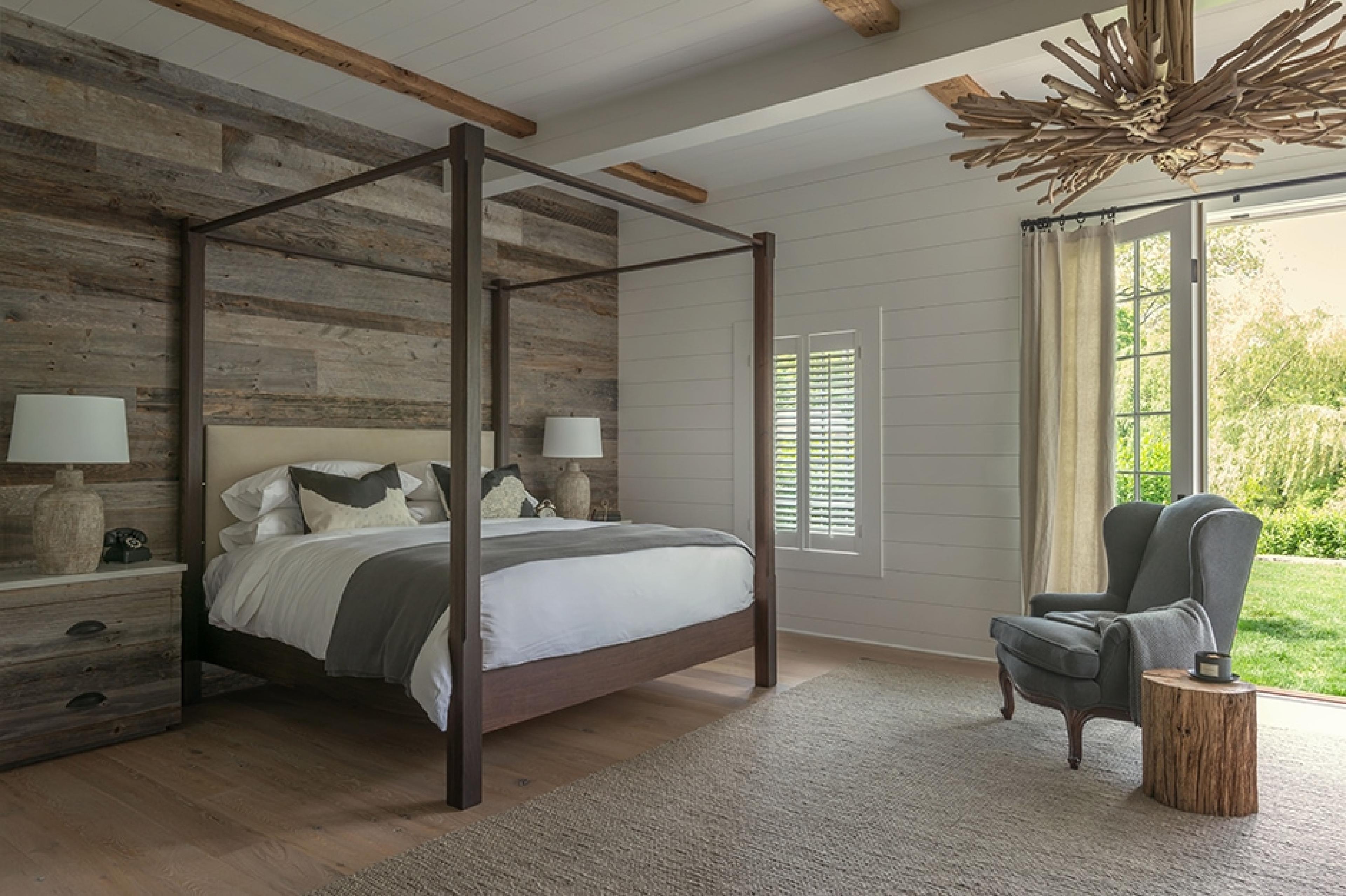 hotel bedroom with four-poster bed and wooden wall