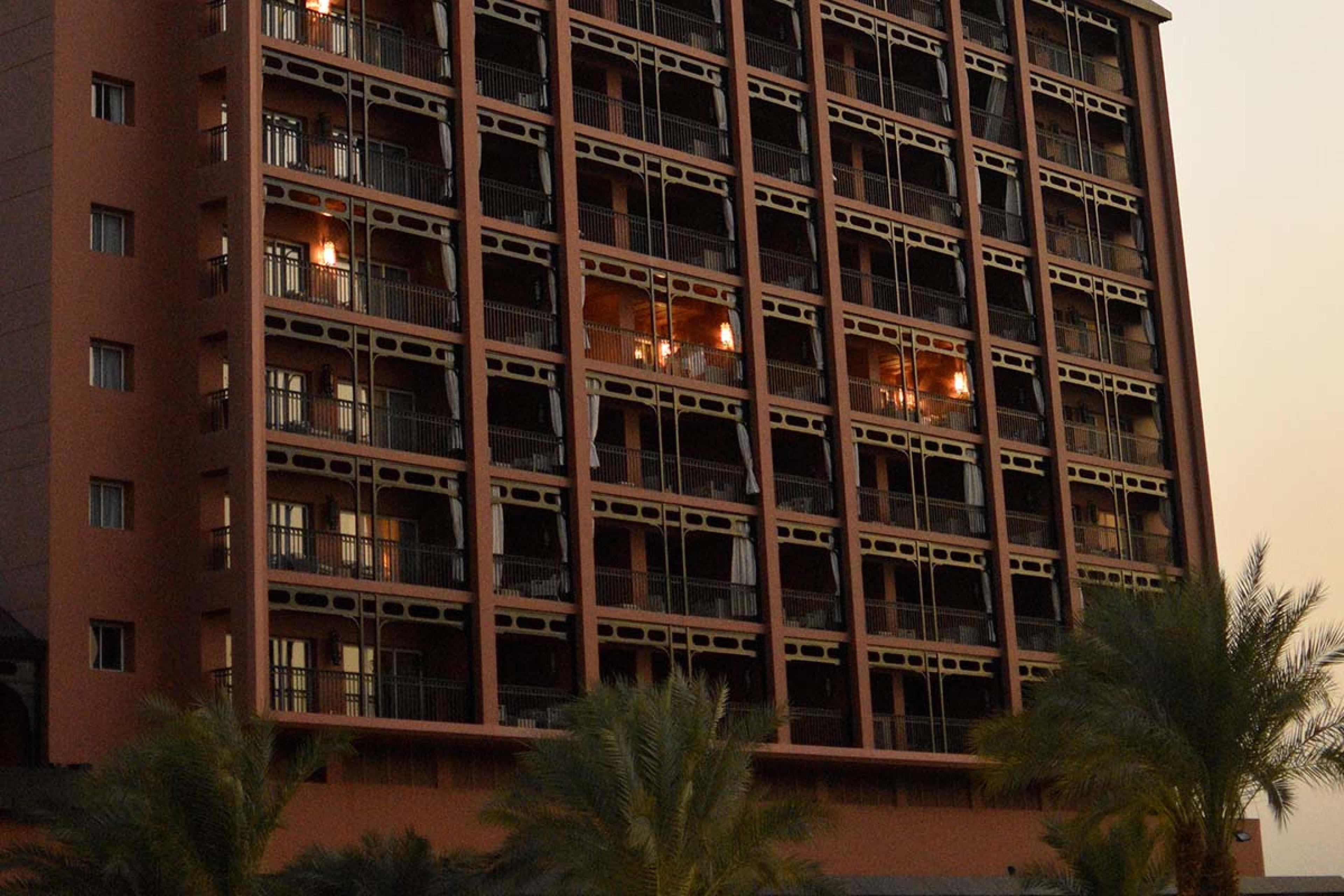 darkly lit hotel with palm trees outside
