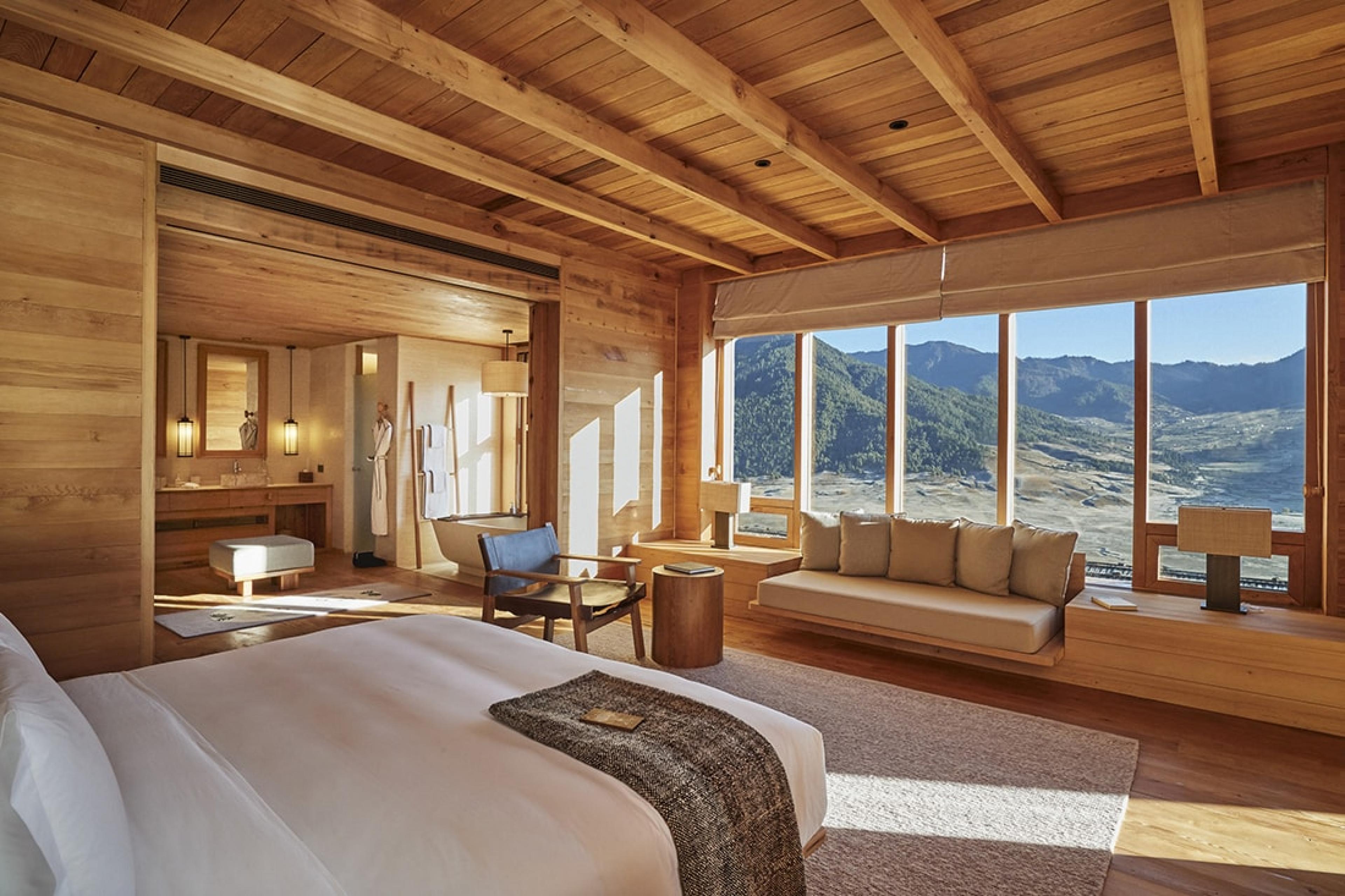 wood paneled bedroom with view over valley in bhutan
