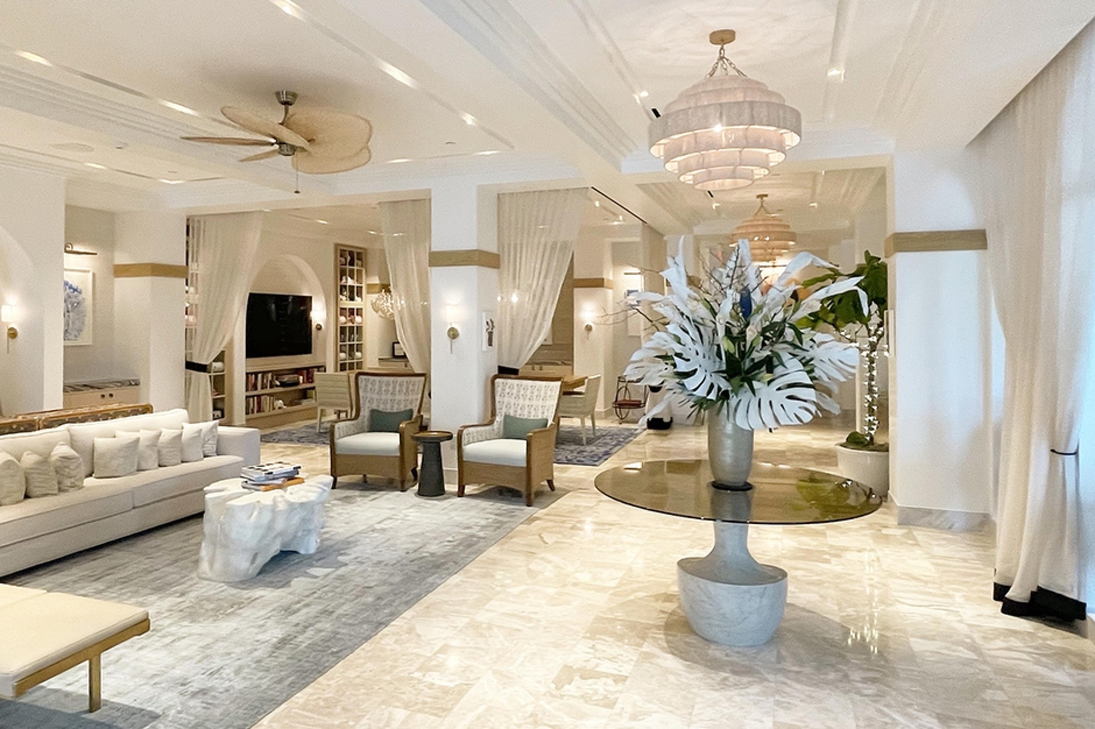 grand hotel lobby with bright lighting and sleek, luxe decor