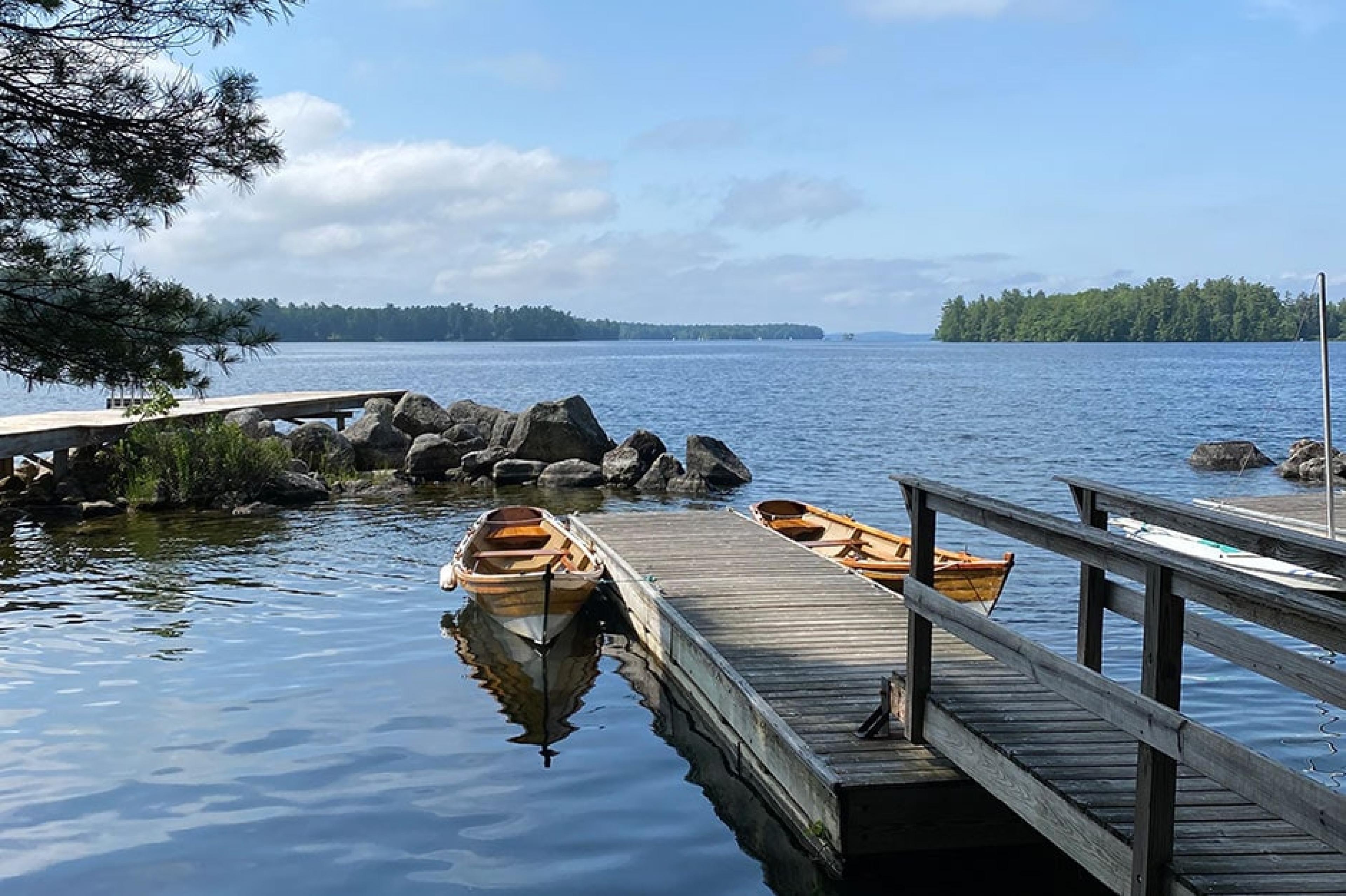 A morning view of boats on the water at Migis Lodge on Sebago Lake in Maine