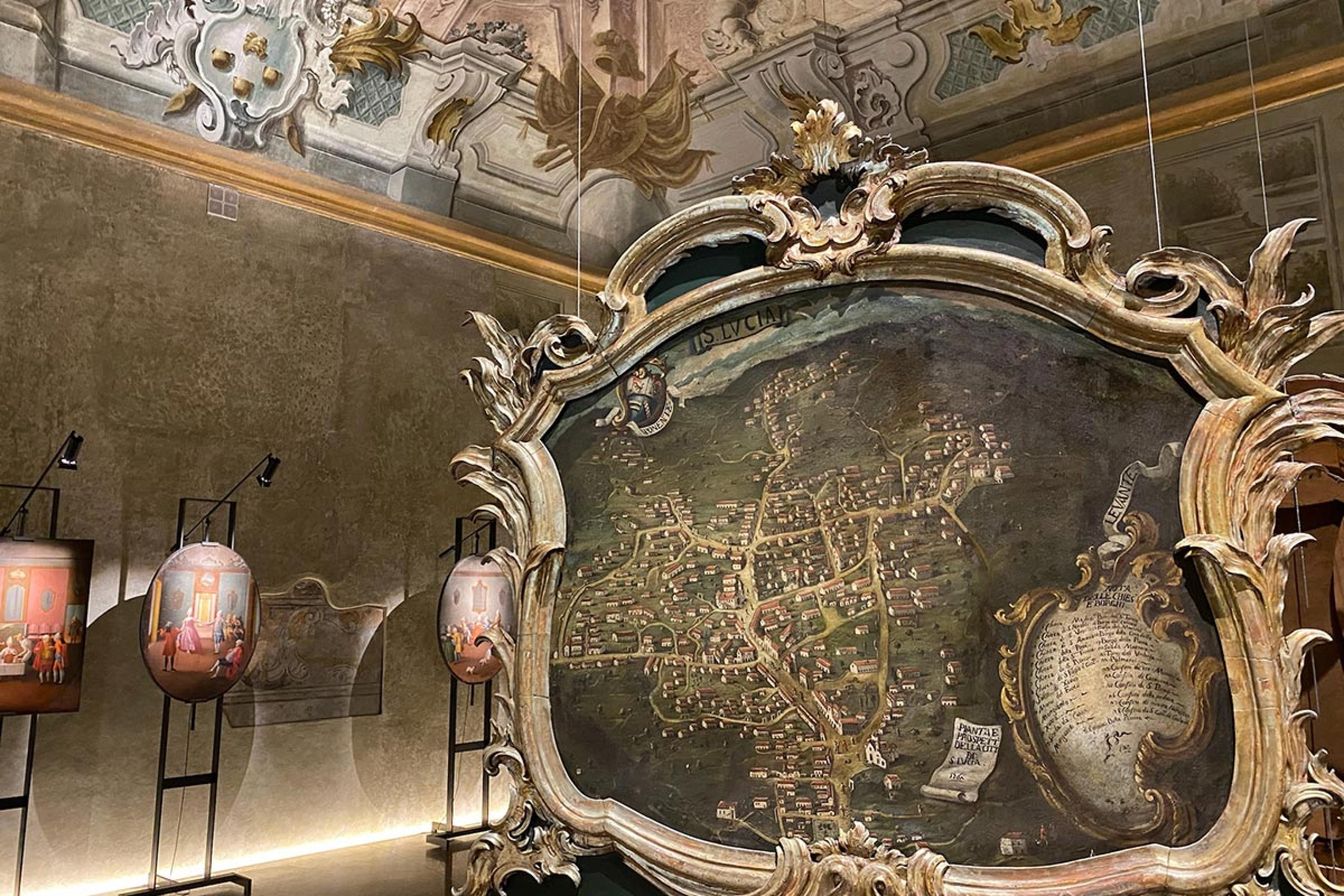 historic map in a gilded frame inside an art gallery with baroque vaulted ceiling