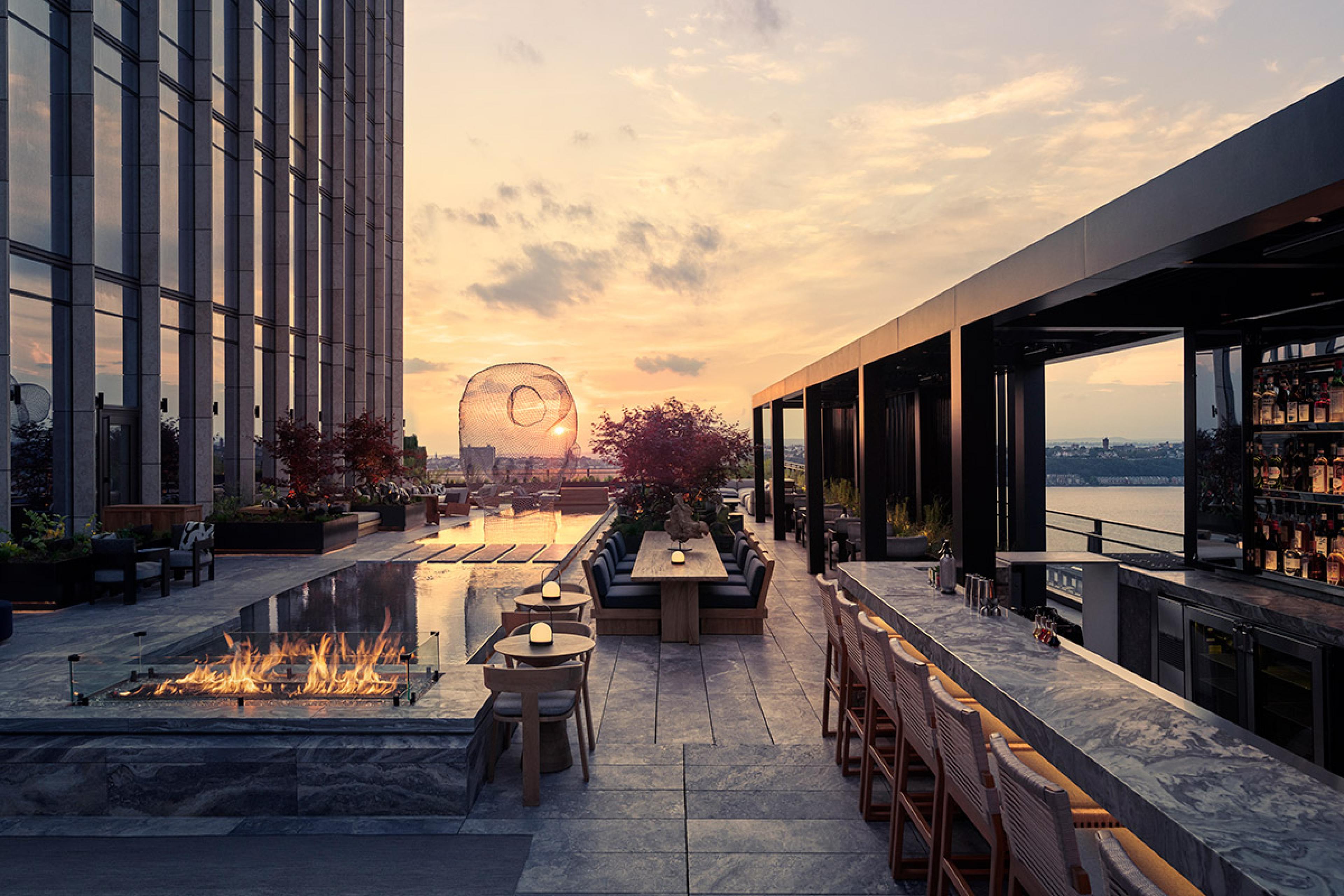 outdoor terrace at sunset on a skyscraper with a water pool and firepit 