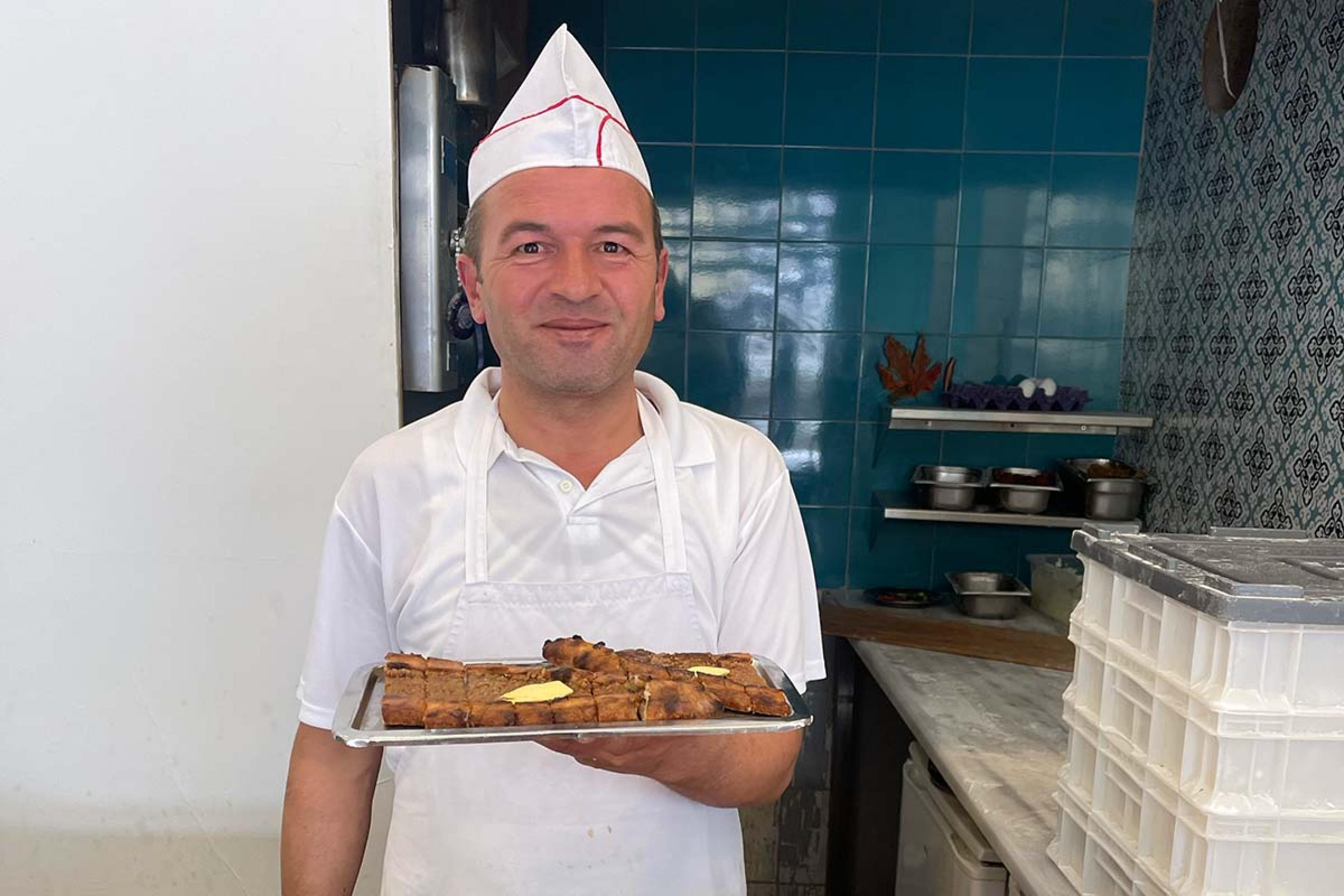 chef holding a platter of baked treats