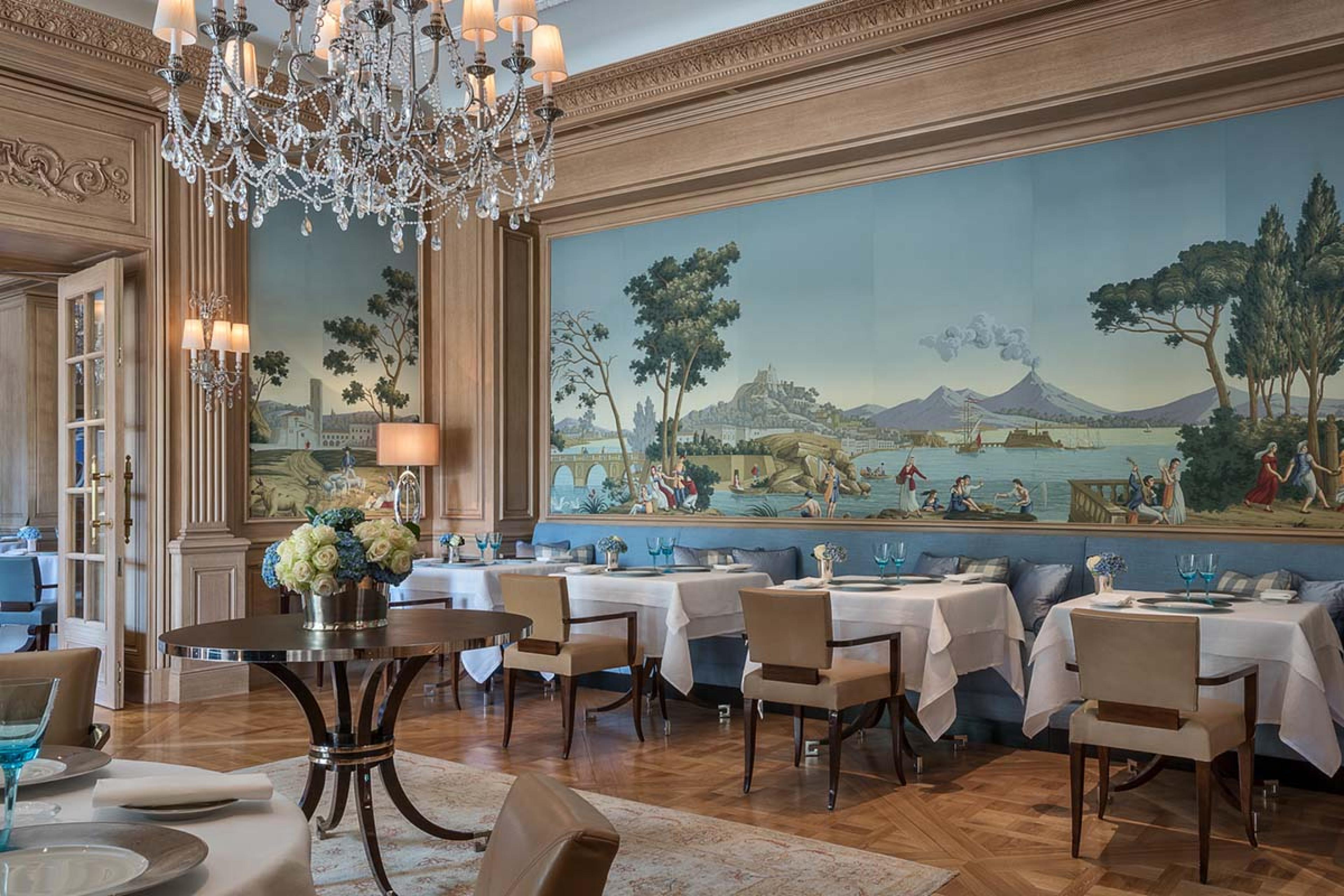 dining room with a frescoes wall and a crystal chandelier