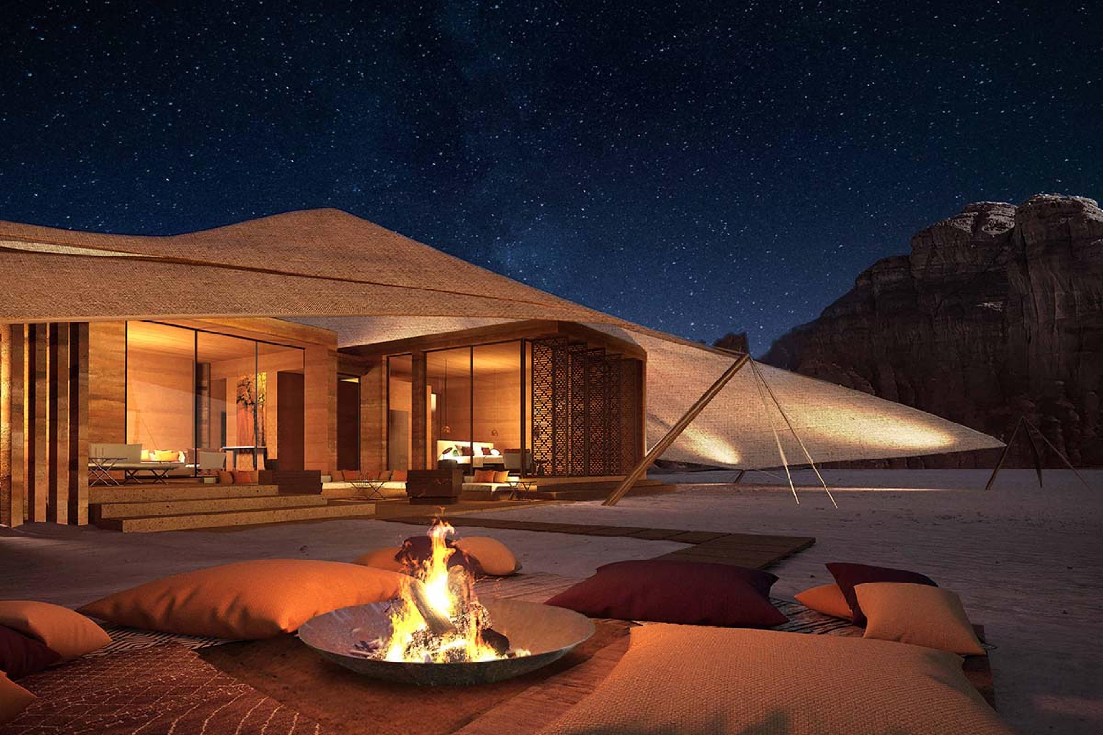 tented villa with an outdoor fire pit at night
