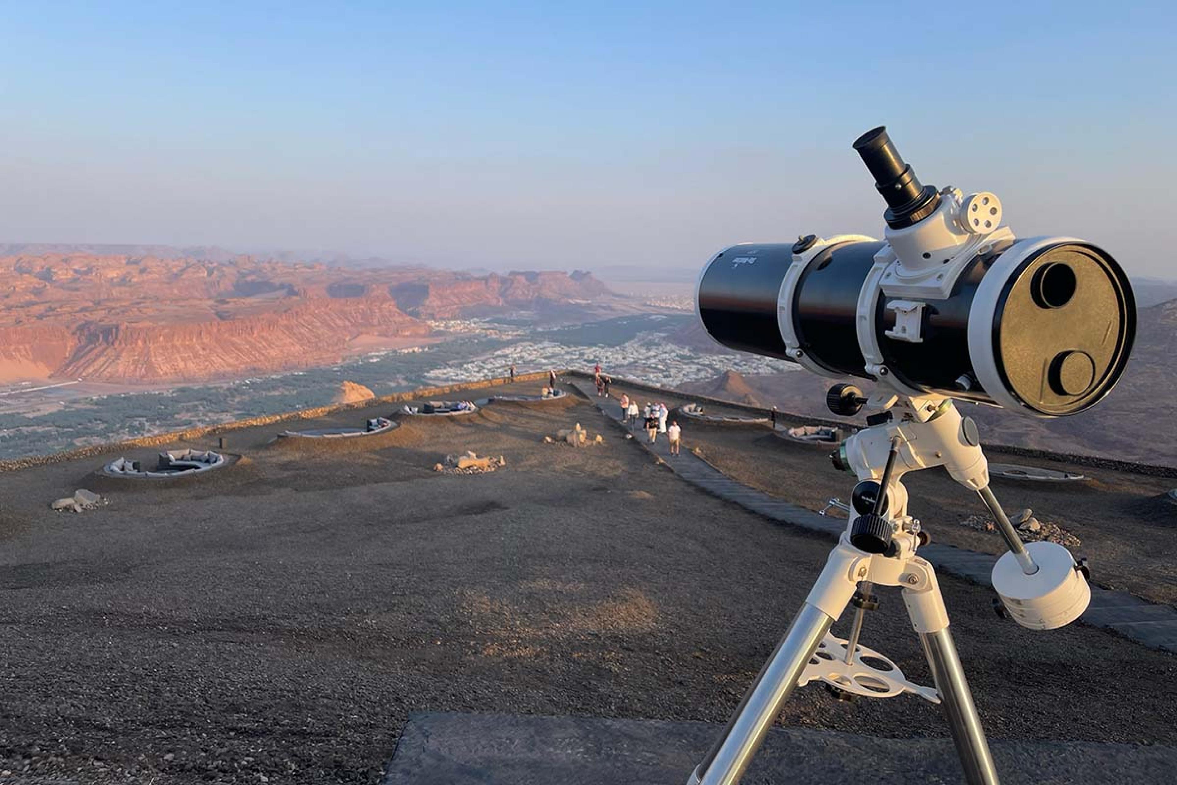 telescope pointed at a pink rocky landscape