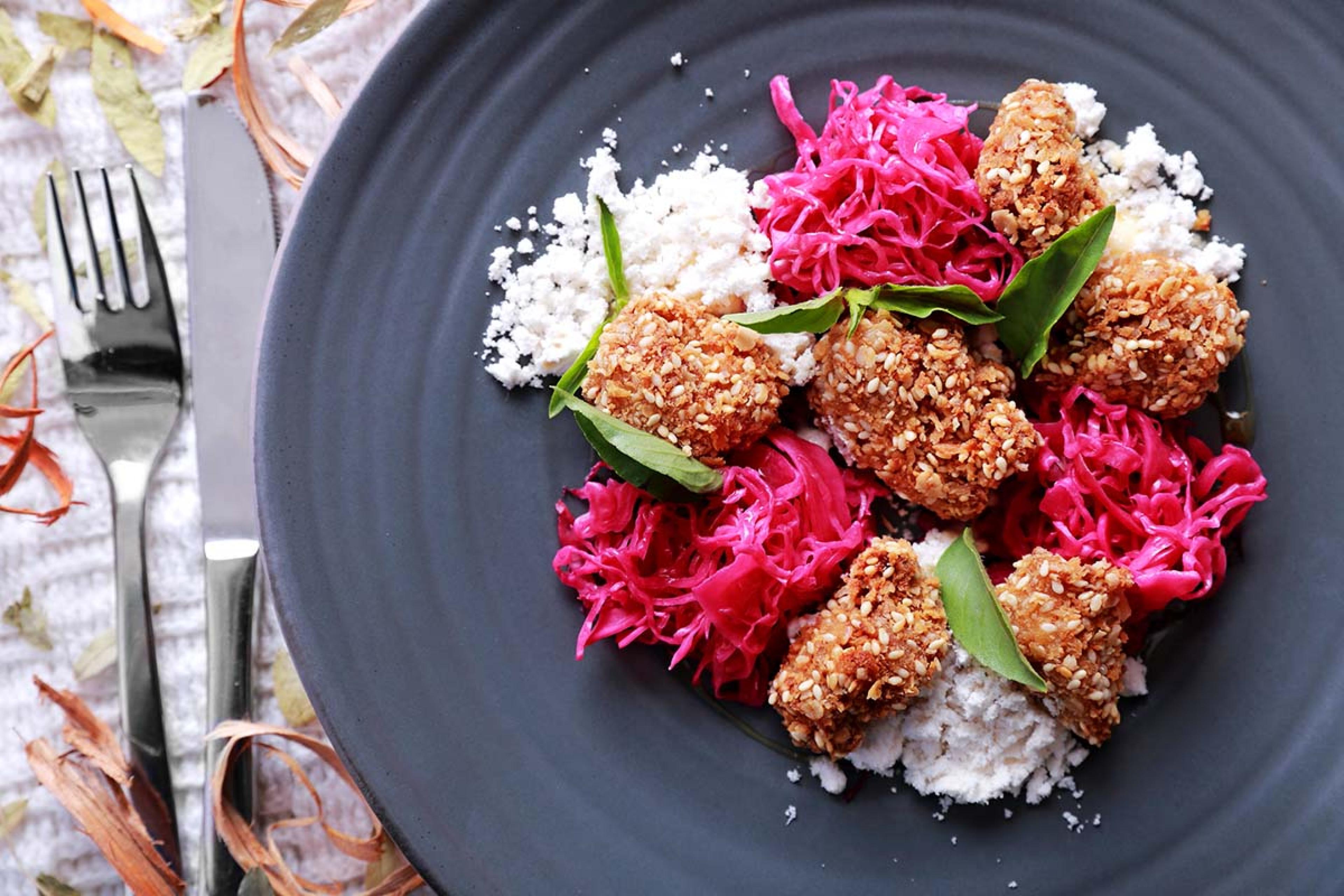 crispy chicken on a plate with pickled onion