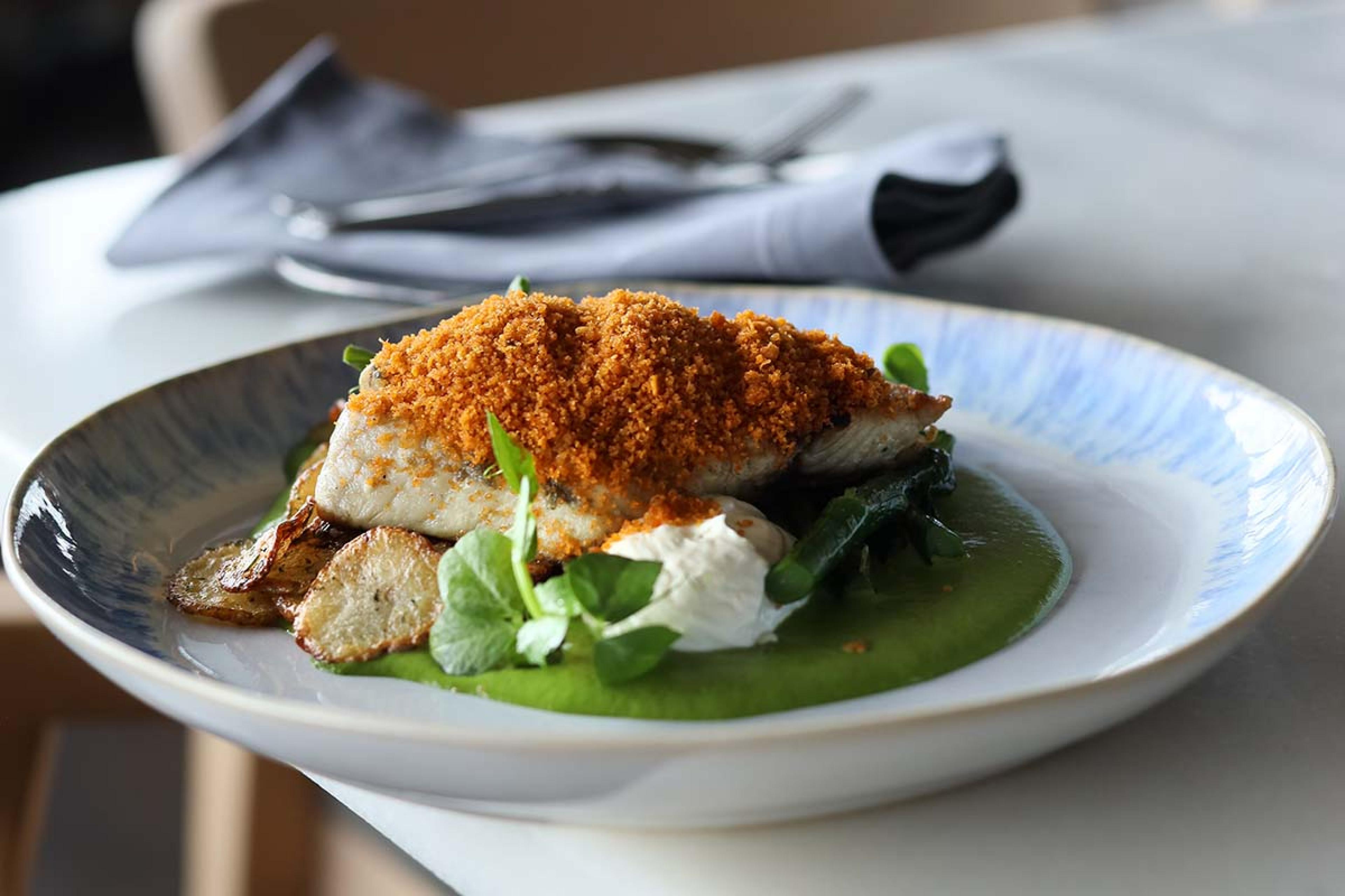 fish with breadcrumbs on a white plate
