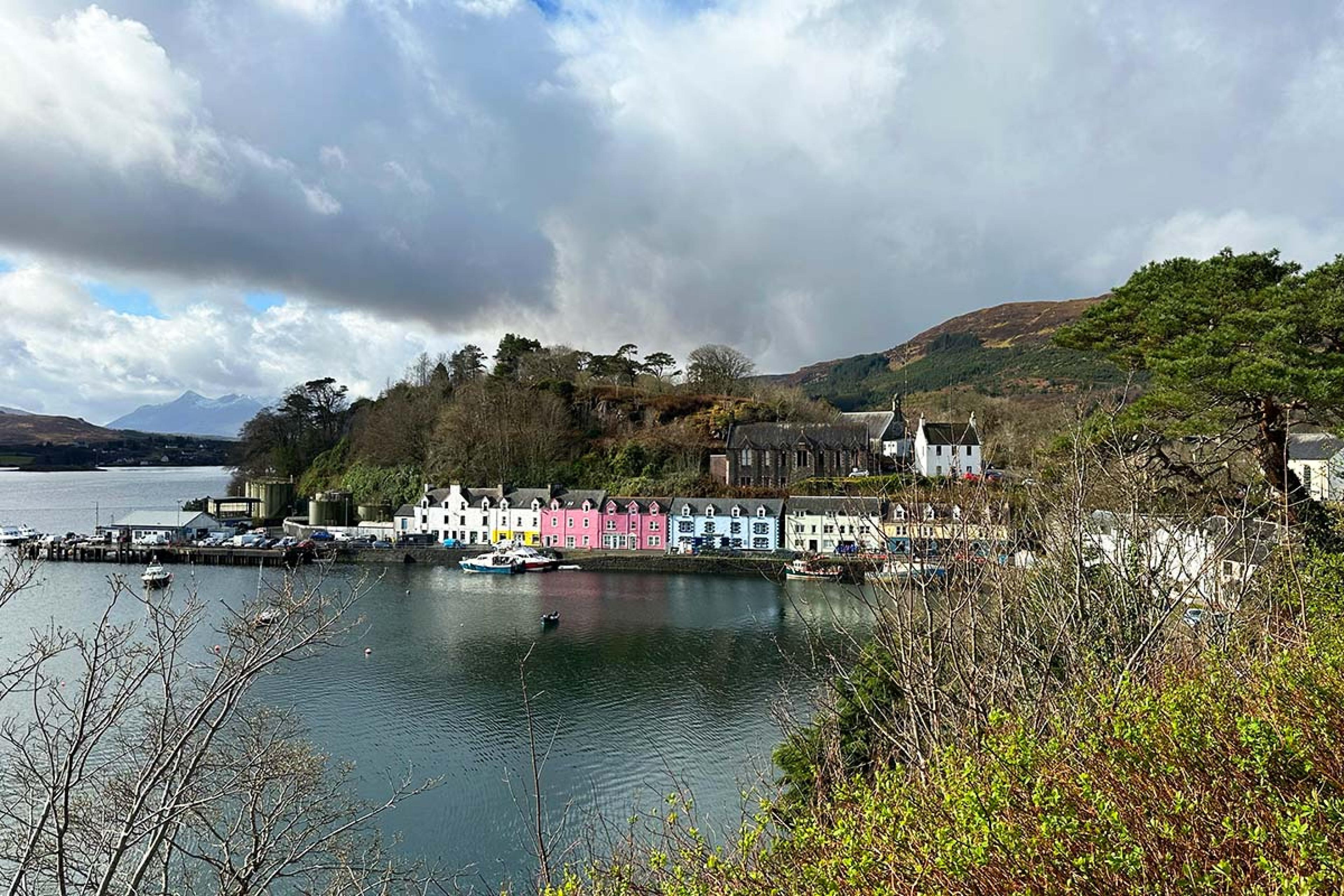 colorful houses along a bay with a hilly backdrop