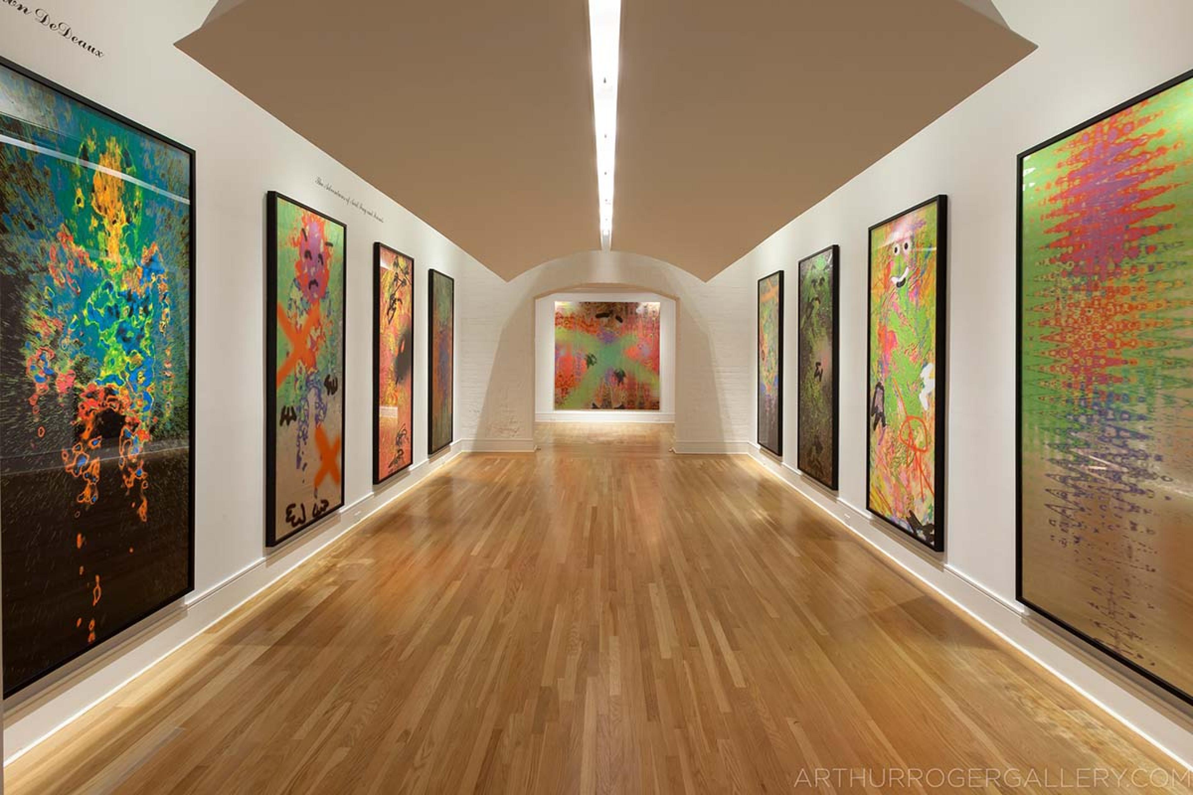 gallery space with polished wooden ceilings and tall paintings lining the white walls