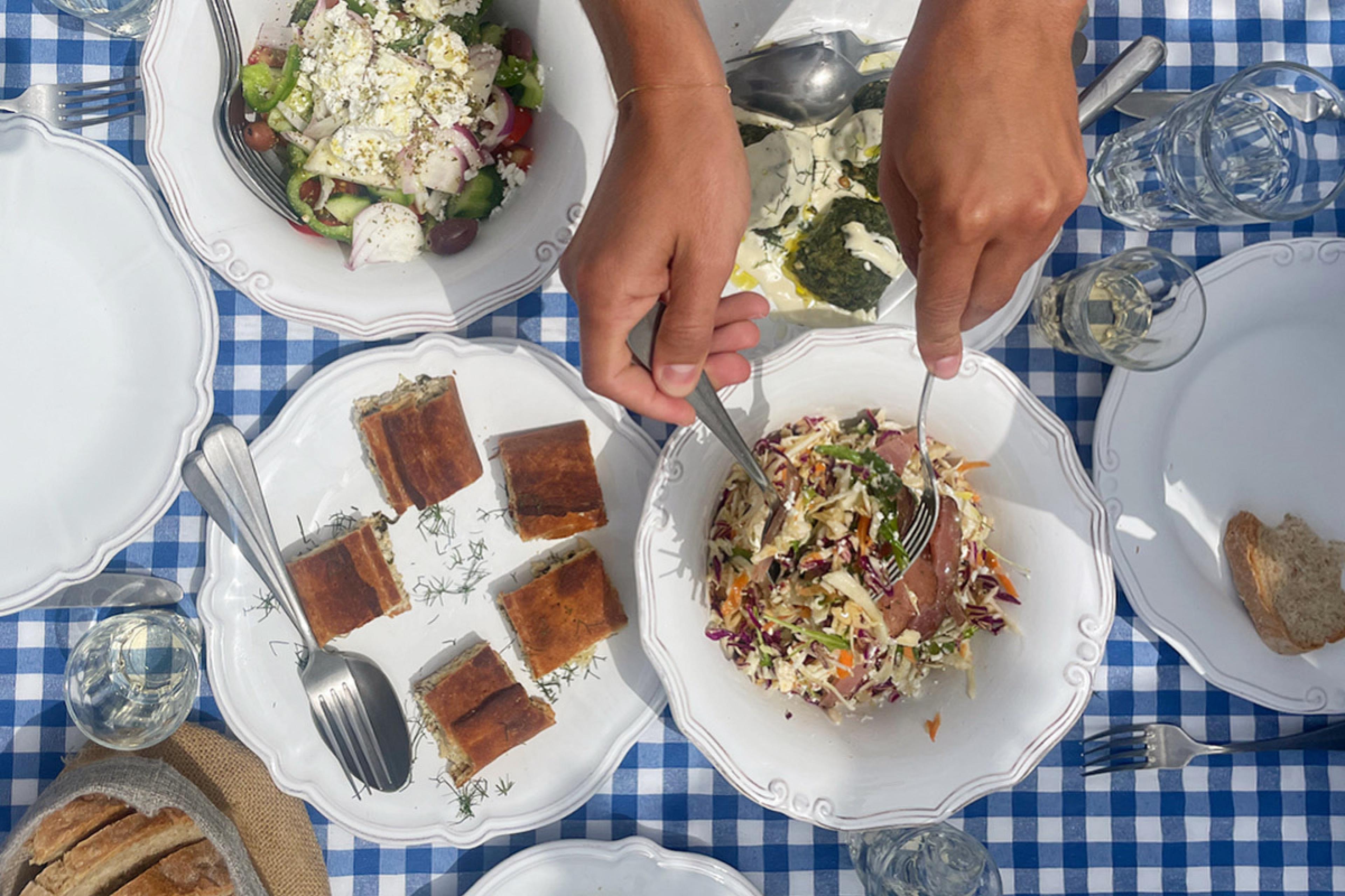 overhead of tablescape with salads at a greek restaurant