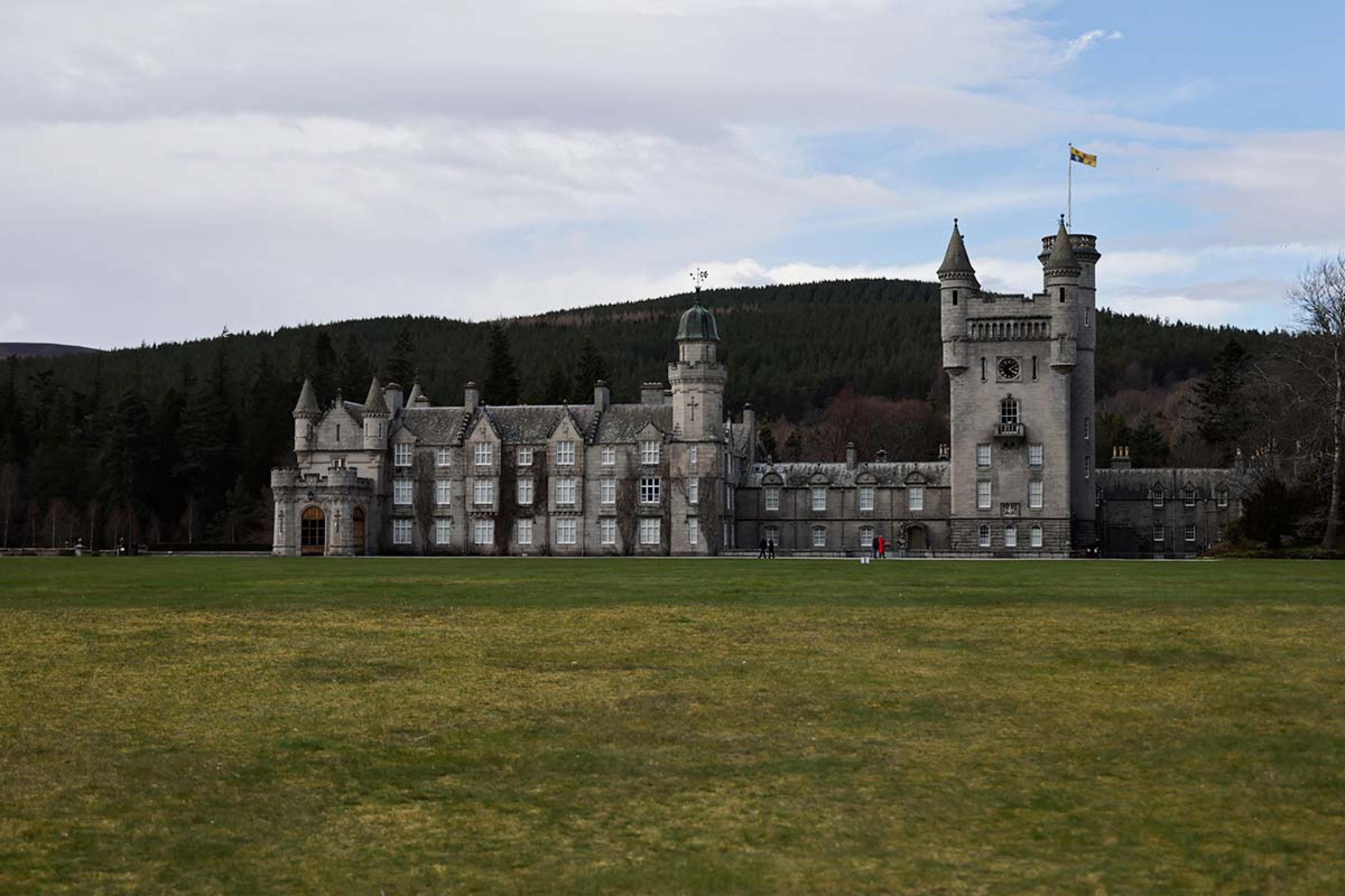 stone castle in Scotland with a long green lawn