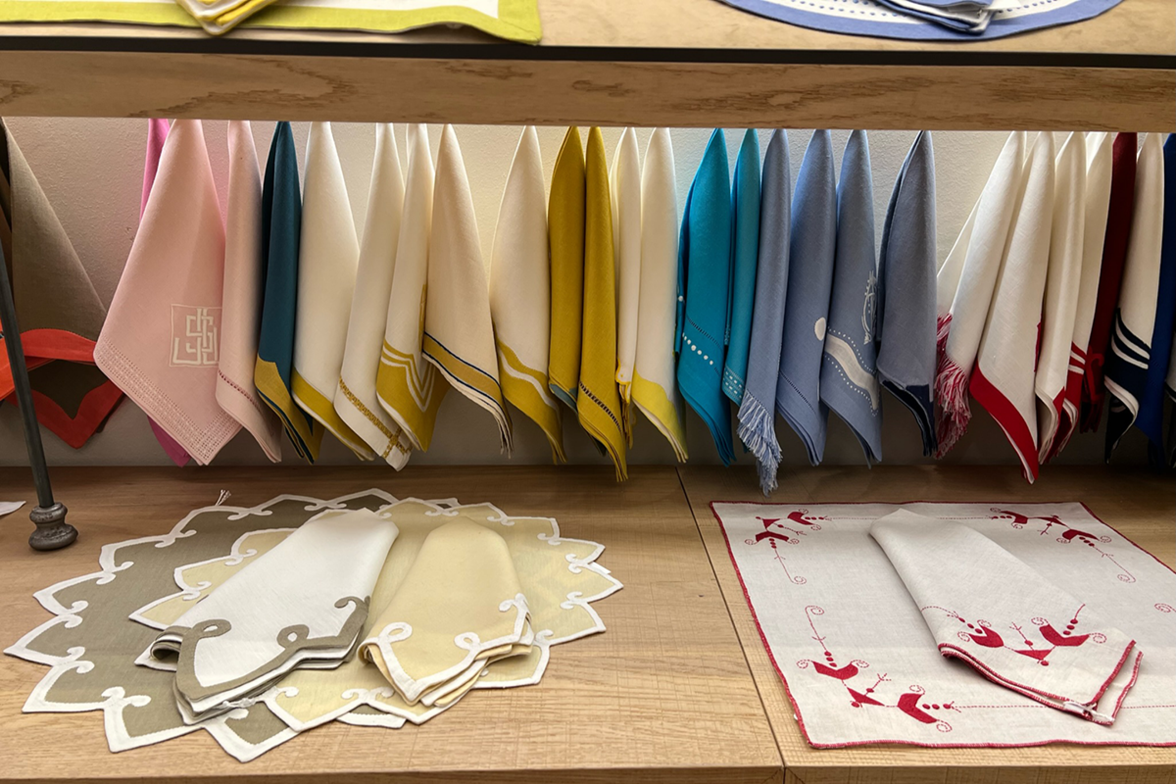 fine cloth napkins hanging over a pale wooden table