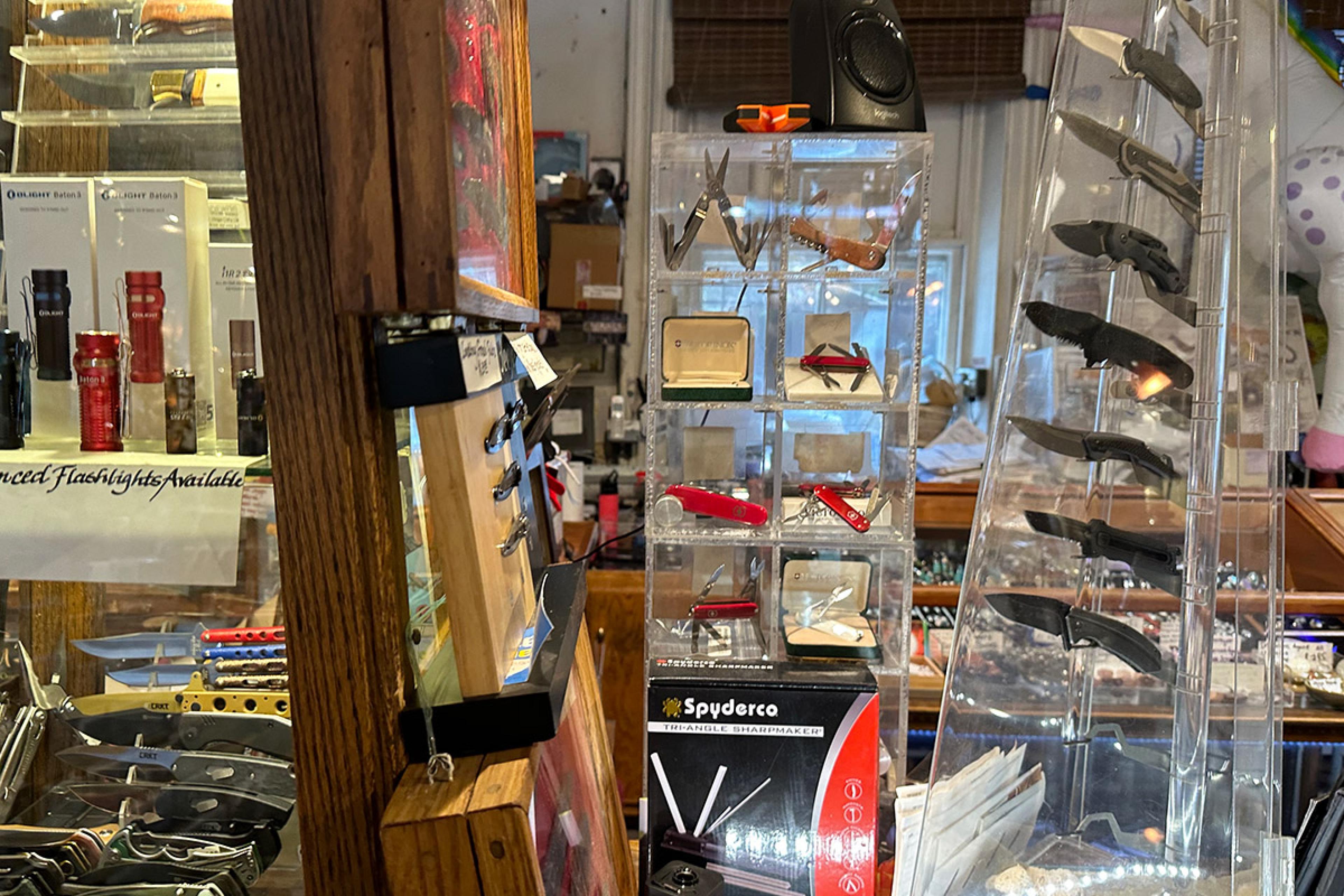 pocket knives and swiss army knives on display in a shop