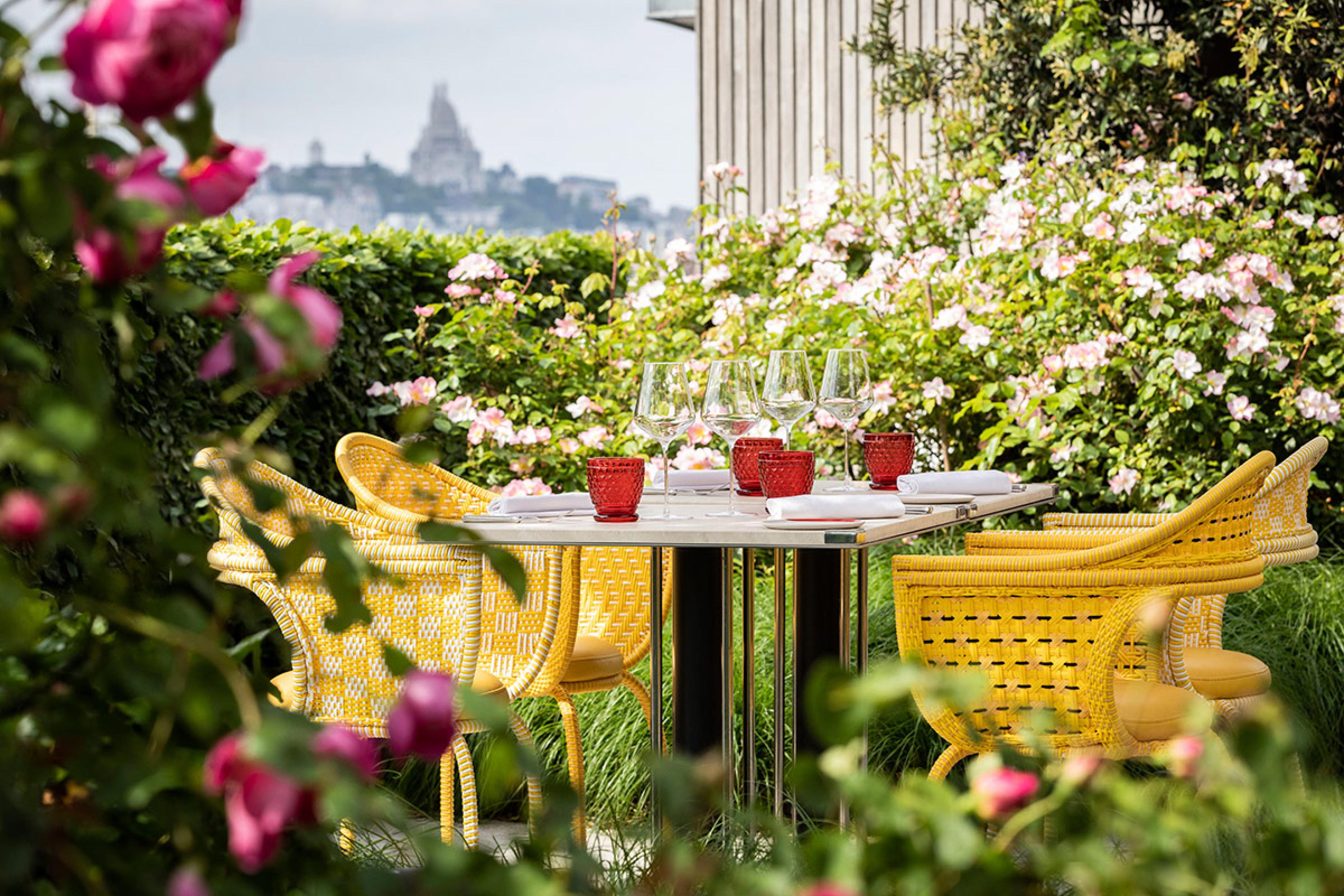 paris rooftop garden with yellow chairs and a view of montmartre