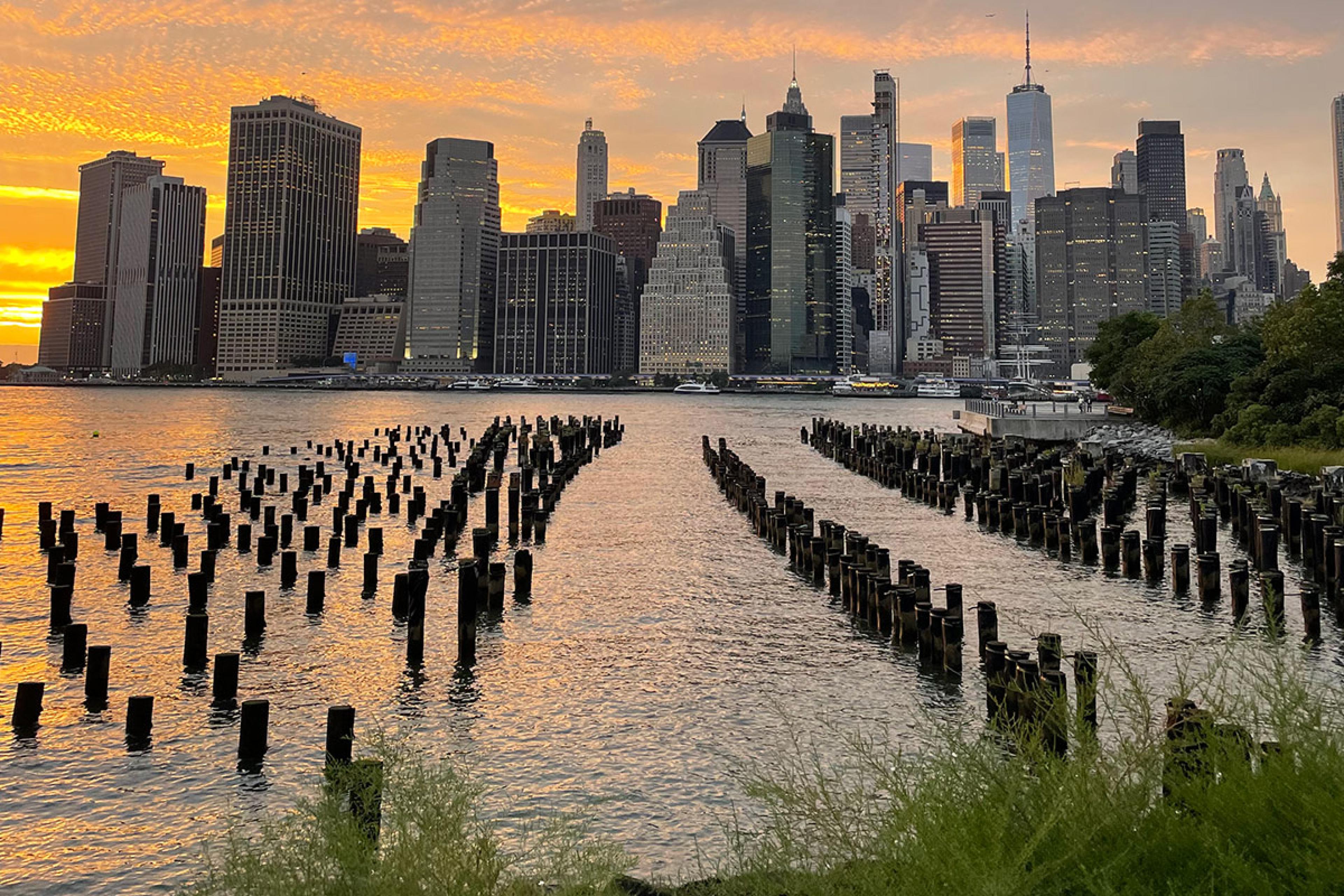 brooklyn bridge park views of lower manhattan over the water at sunset