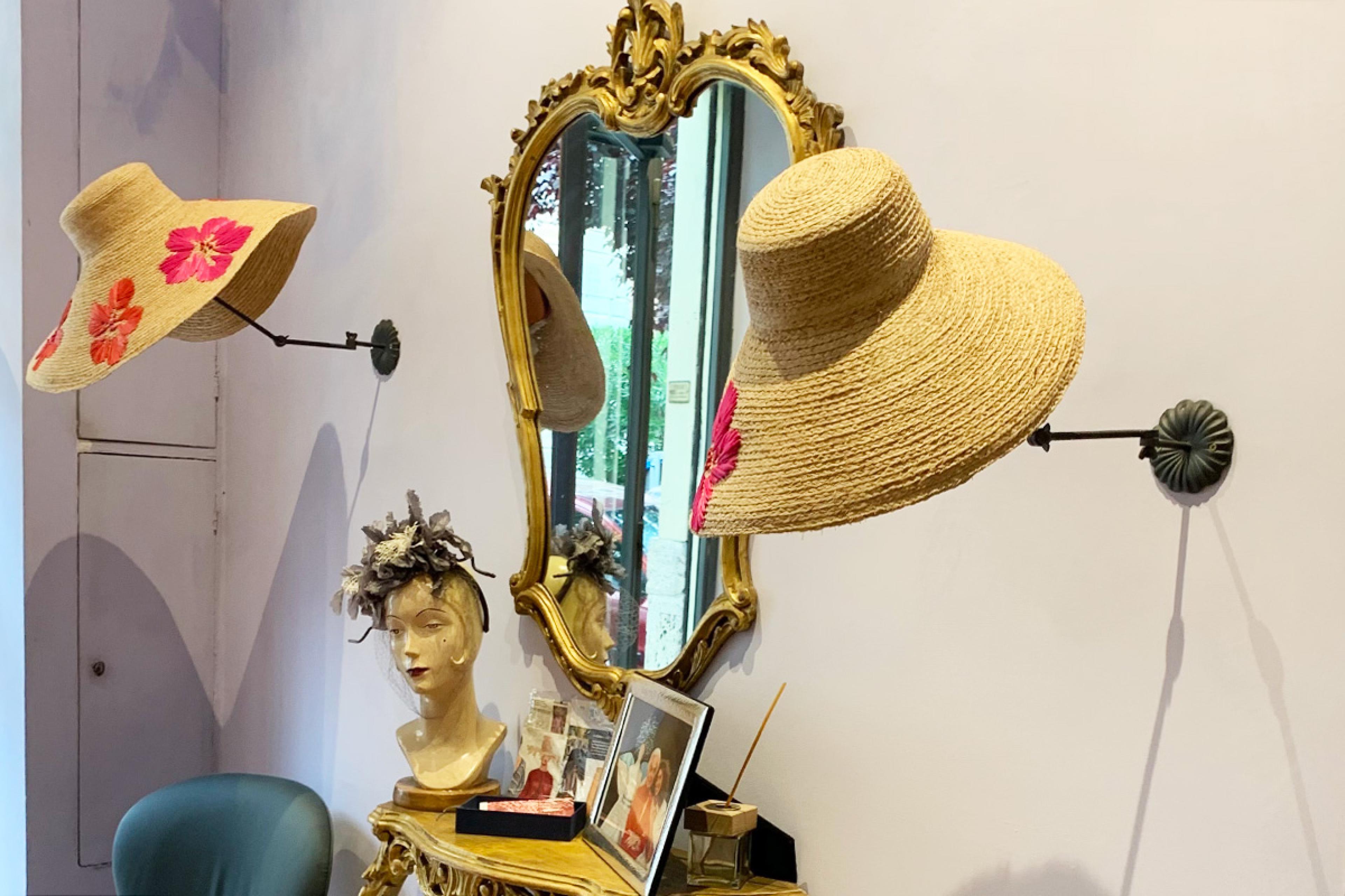 hats displayed on a wall in a hat boutique