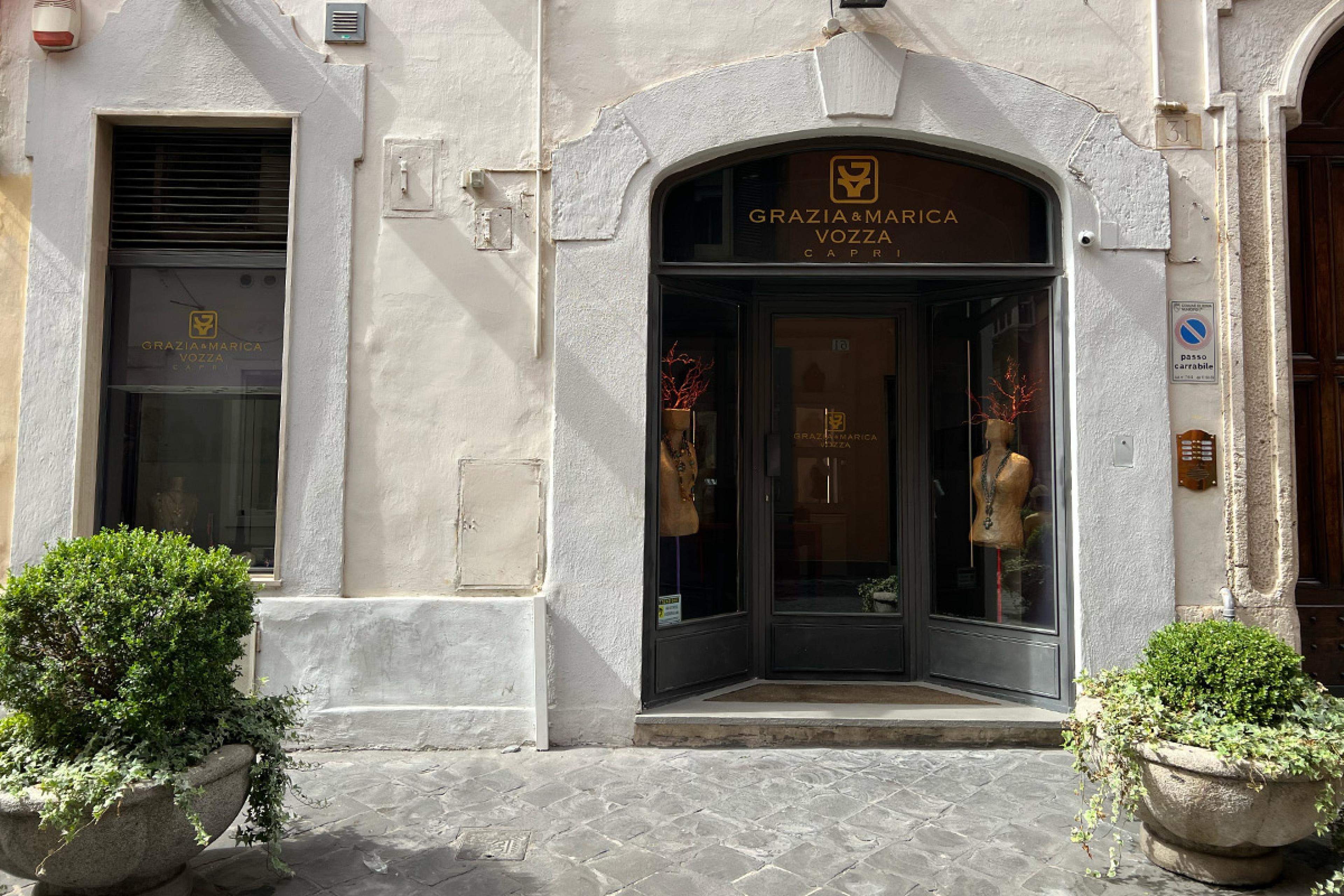 exterior of store in rome with sign on glass door saying Grazie e Marica Vozza