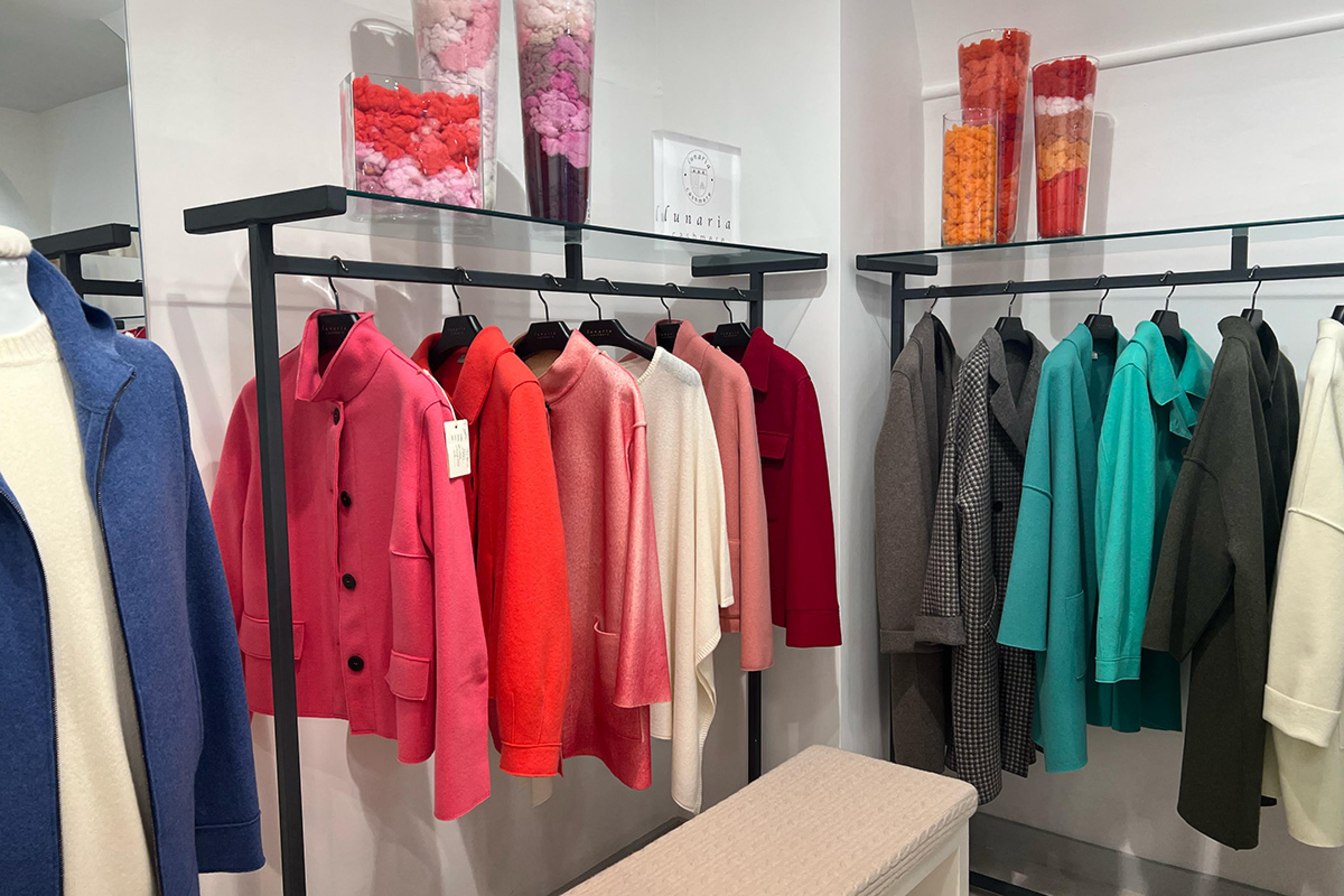 black clothing racks with colorful cashmere