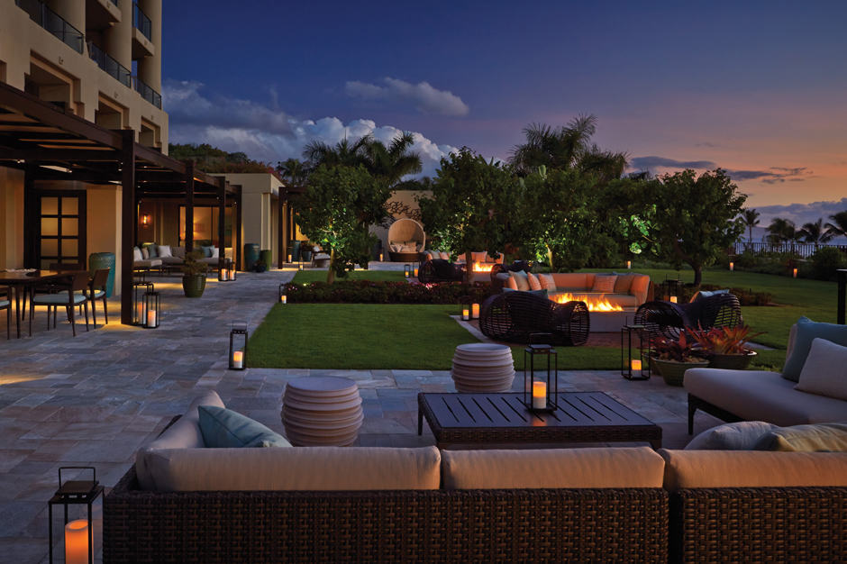 Outdoor lounge area with firepit at night at Four Seasons Resort Maui at Wailea