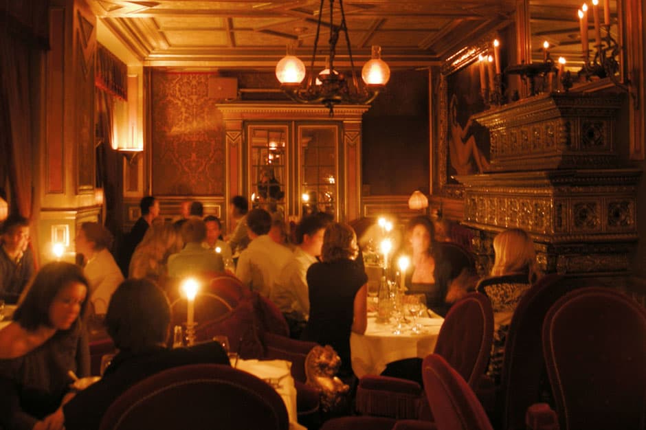 Crowded candlelit restaurant at the Hotel Costes in Paris France