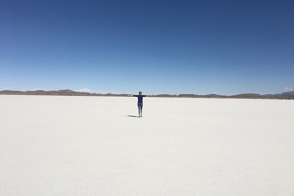 Elise Bronzo of Indagare standing alone in Bolivian salt flats