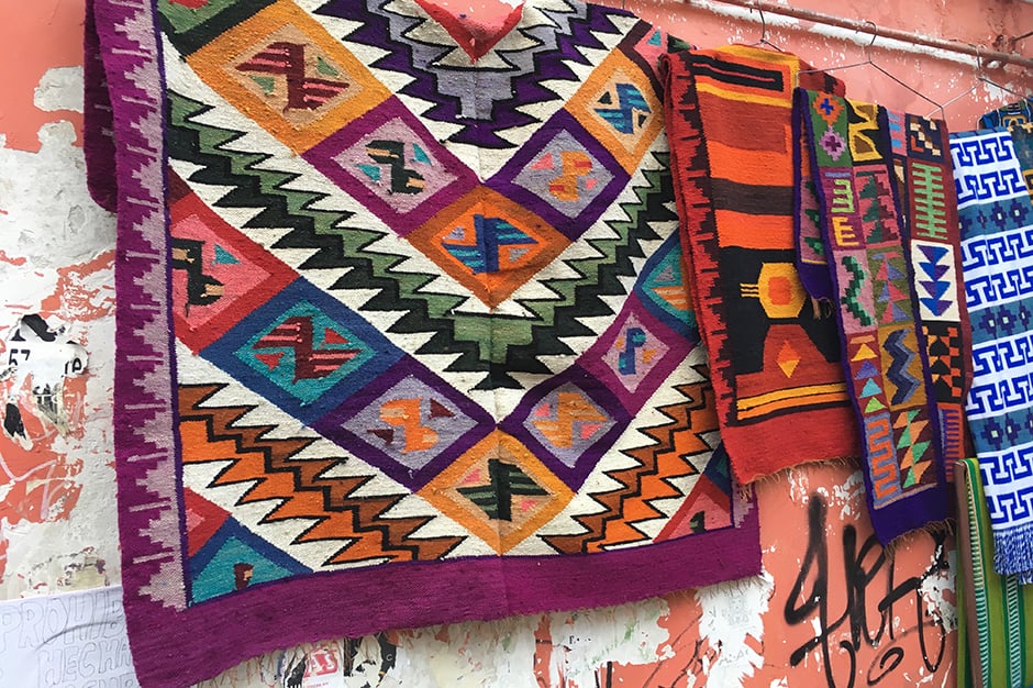 4 colorful weavings hanging on a wall in La Paz Bolivia