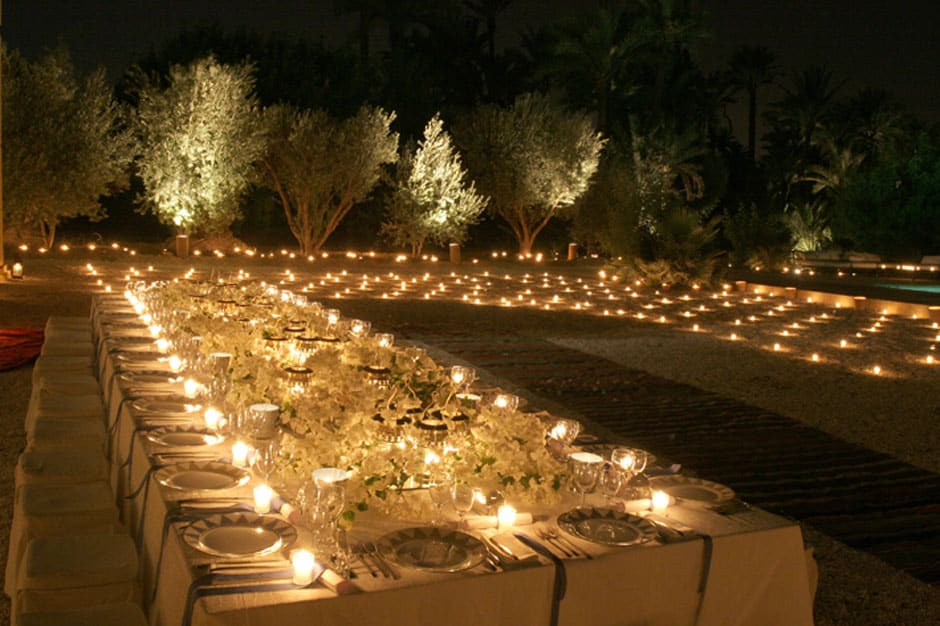 Long candlelit outdoor dining table at Jnane Tamsna hotel in Marrakech