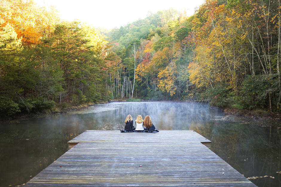 Three women on dock on lake at Blackberry Mountain