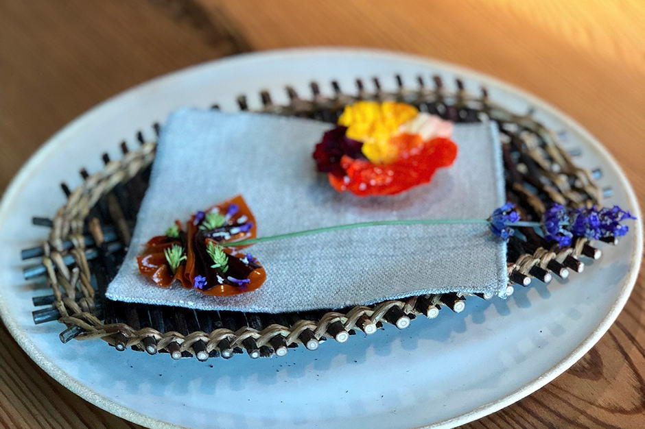 Second course: Nasturtium tart. Set on a reed basket this two-piece course consisted of a thin potato tart with nasturtium and rose and a fruit leather made of carrot, sea buckthorn and black currant. 