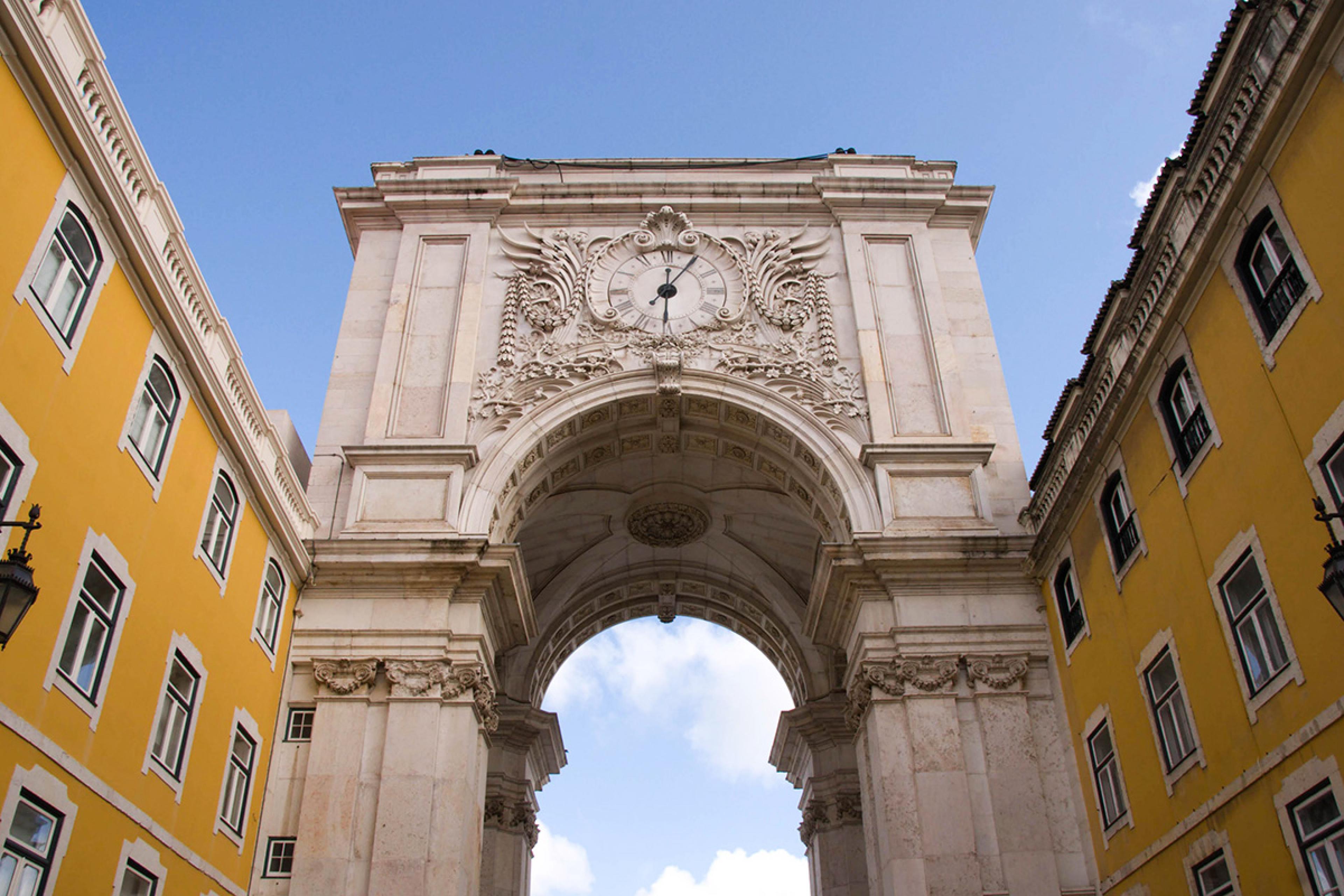 white stone arch with a clock