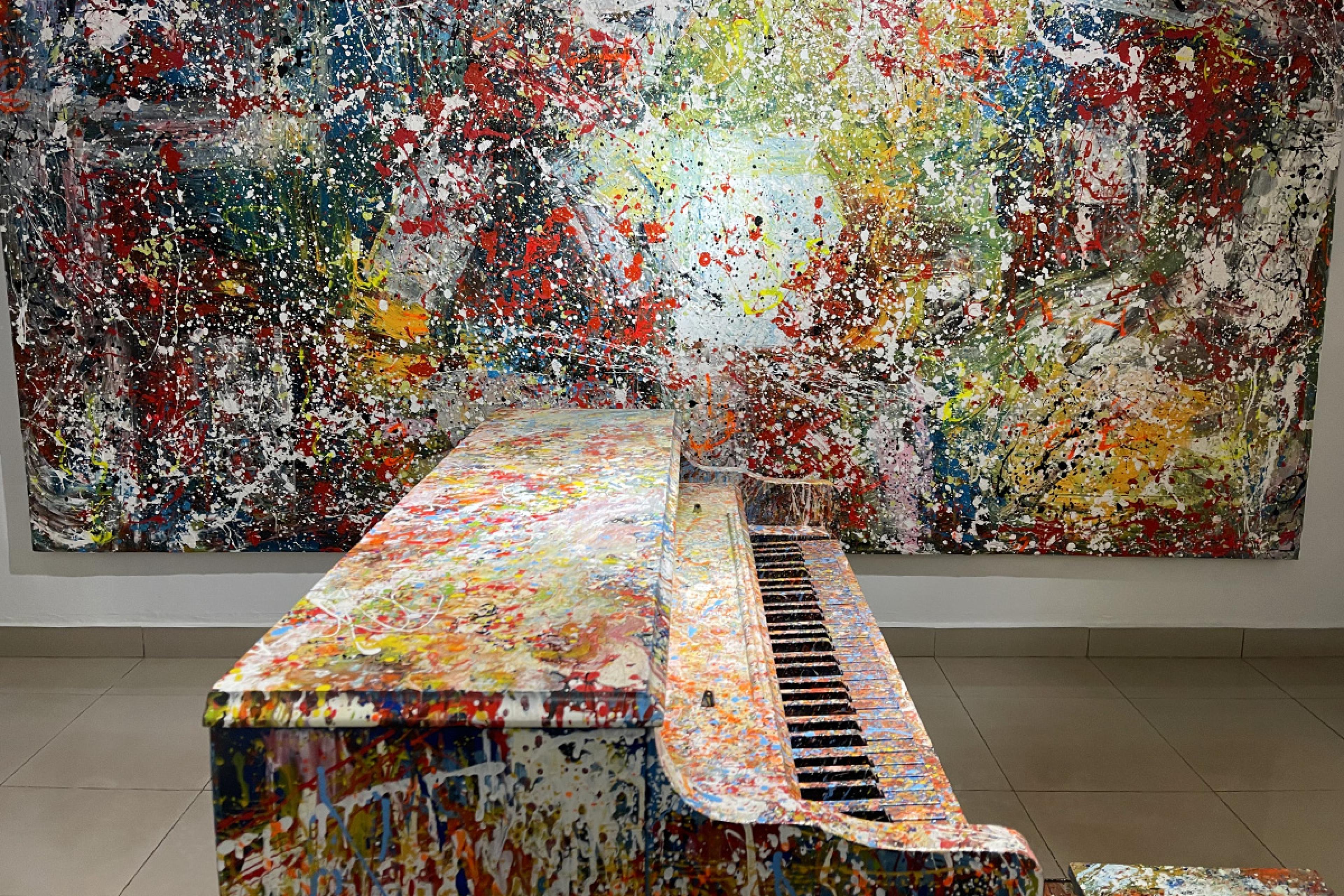 splatter-painted piano and wall