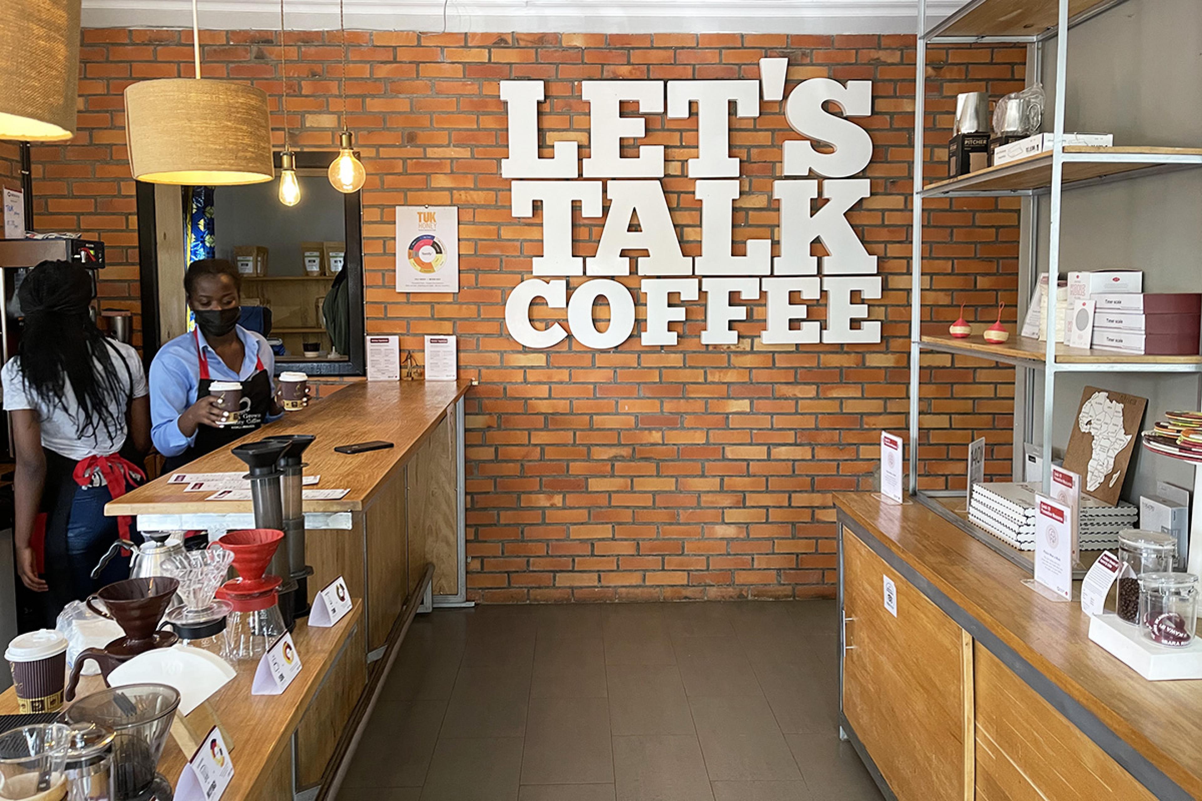 brick coffee shop interior with white lettering on the wall