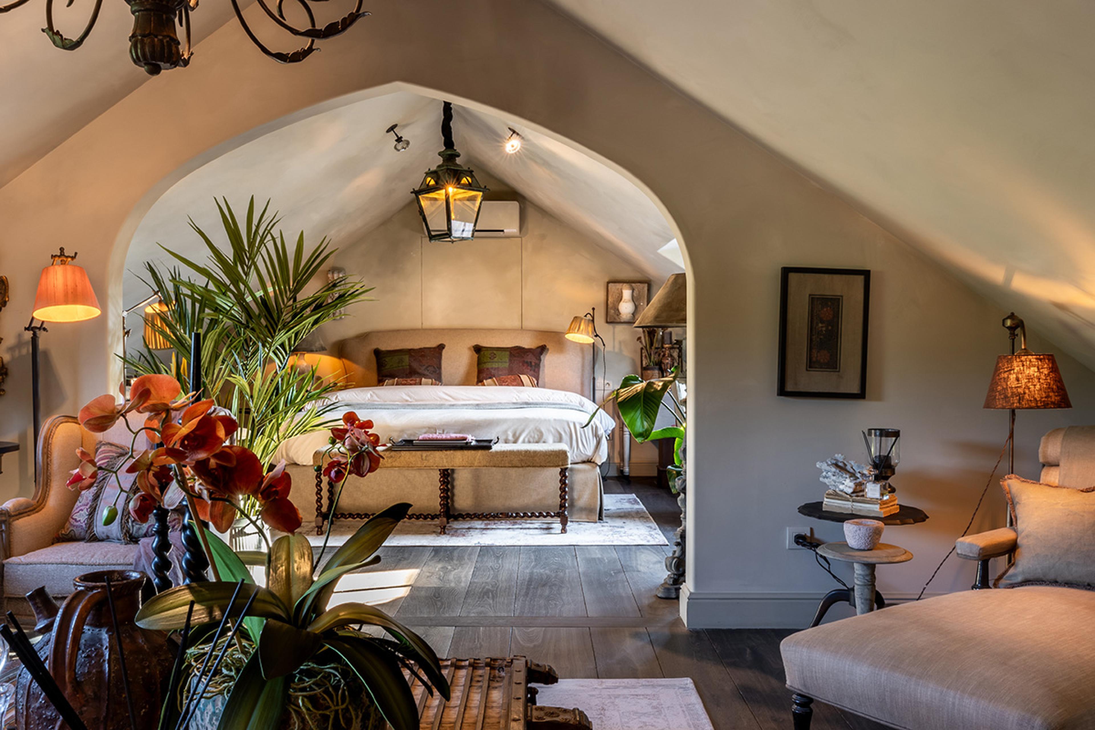 bedroom with a pointed arch and plants